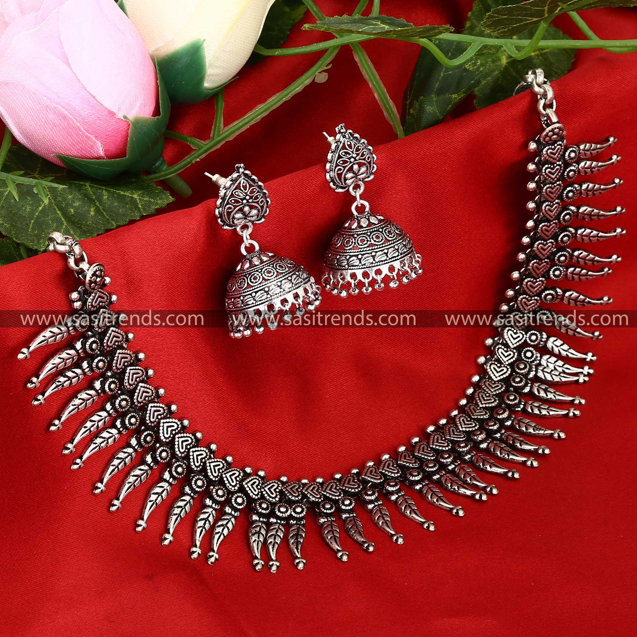 Traditional leaf motif oxidised necklace paired with detailed earrings 