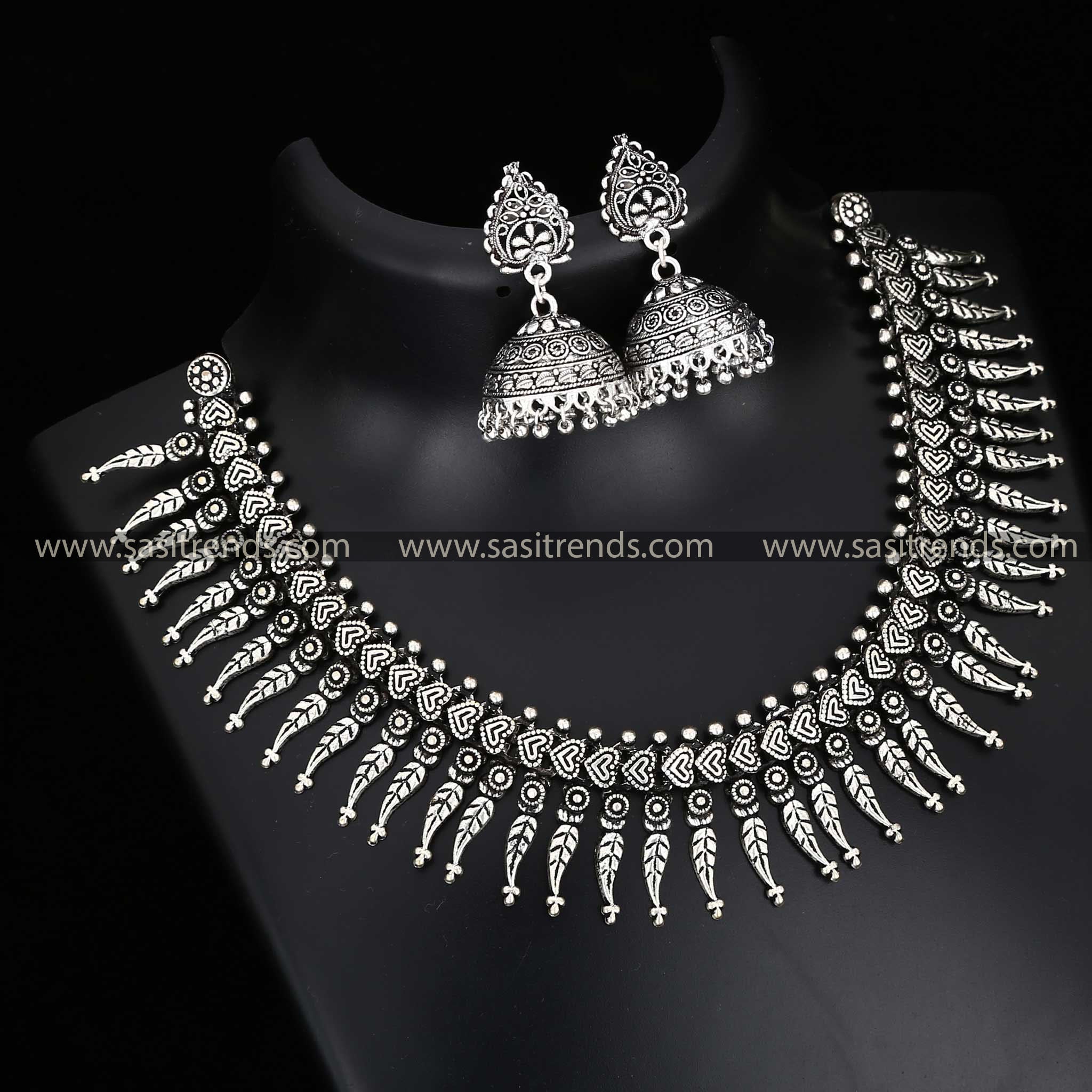 Oxidised artisan necklace with leaf motifs and intricate earrings 