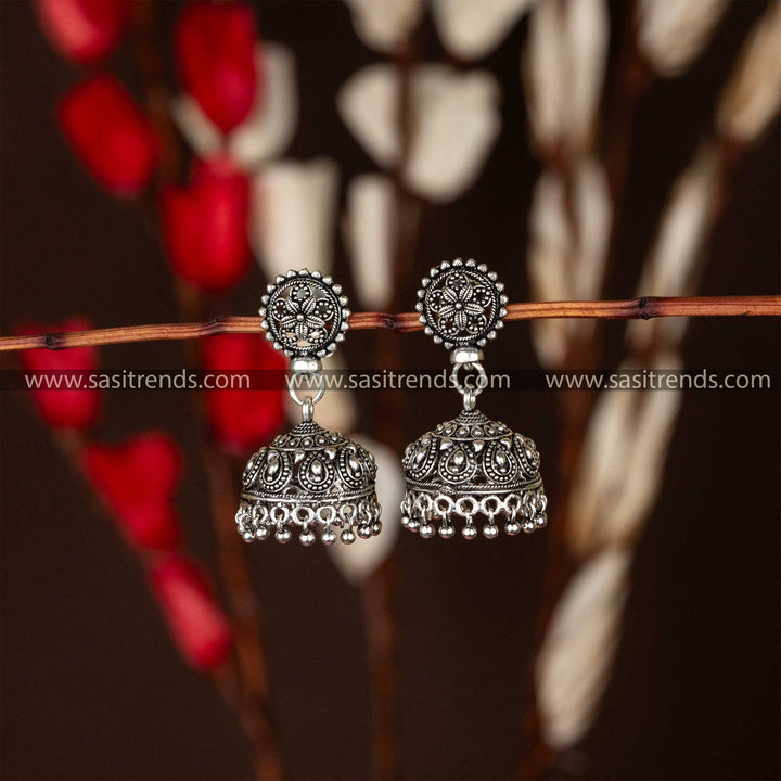 Exquisite oxidised silver jhumkas with detailed carving and classic jhumka silhouette, perfect for traditional wear