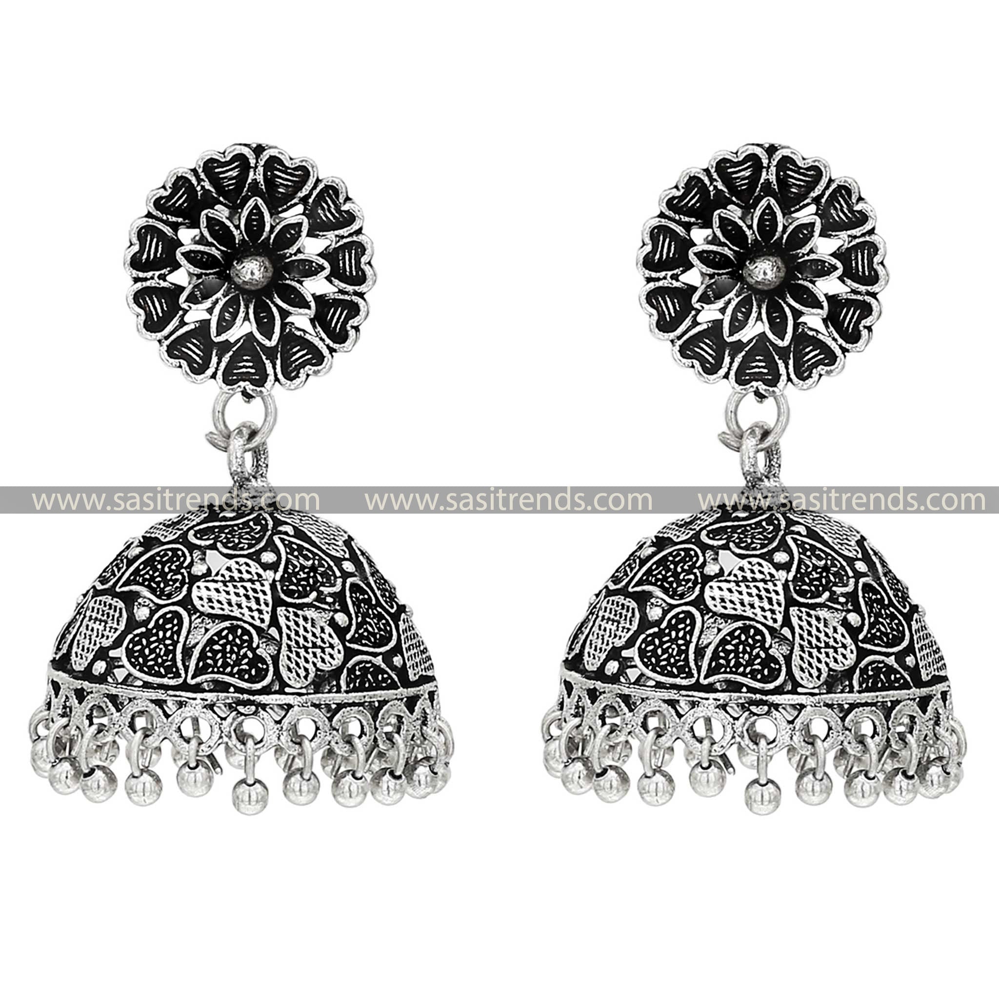 Oxidised silver jhumka earrings with intricate leaf patterns on the chara tops, blending traditional artistry with botanical motifs