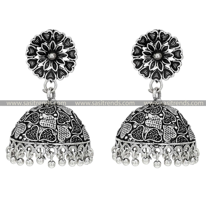 Oxidised silver jhumka earrings with intricate leaf patterns on the chara tops, blending traditional artistry with botanical motifs