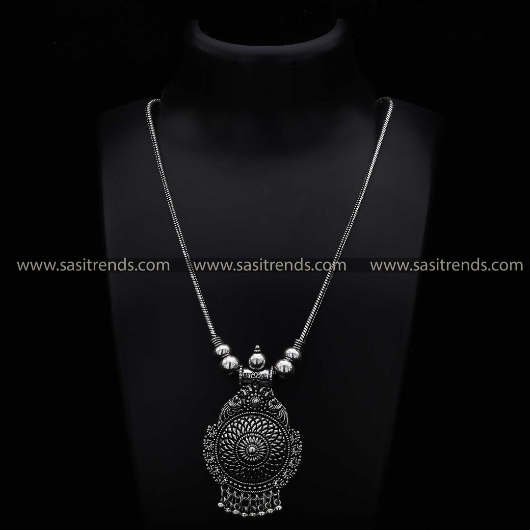 Oxidised silver pendant necklace featuring an intricate mandala peacock design with beaded fringe navarathiri Special