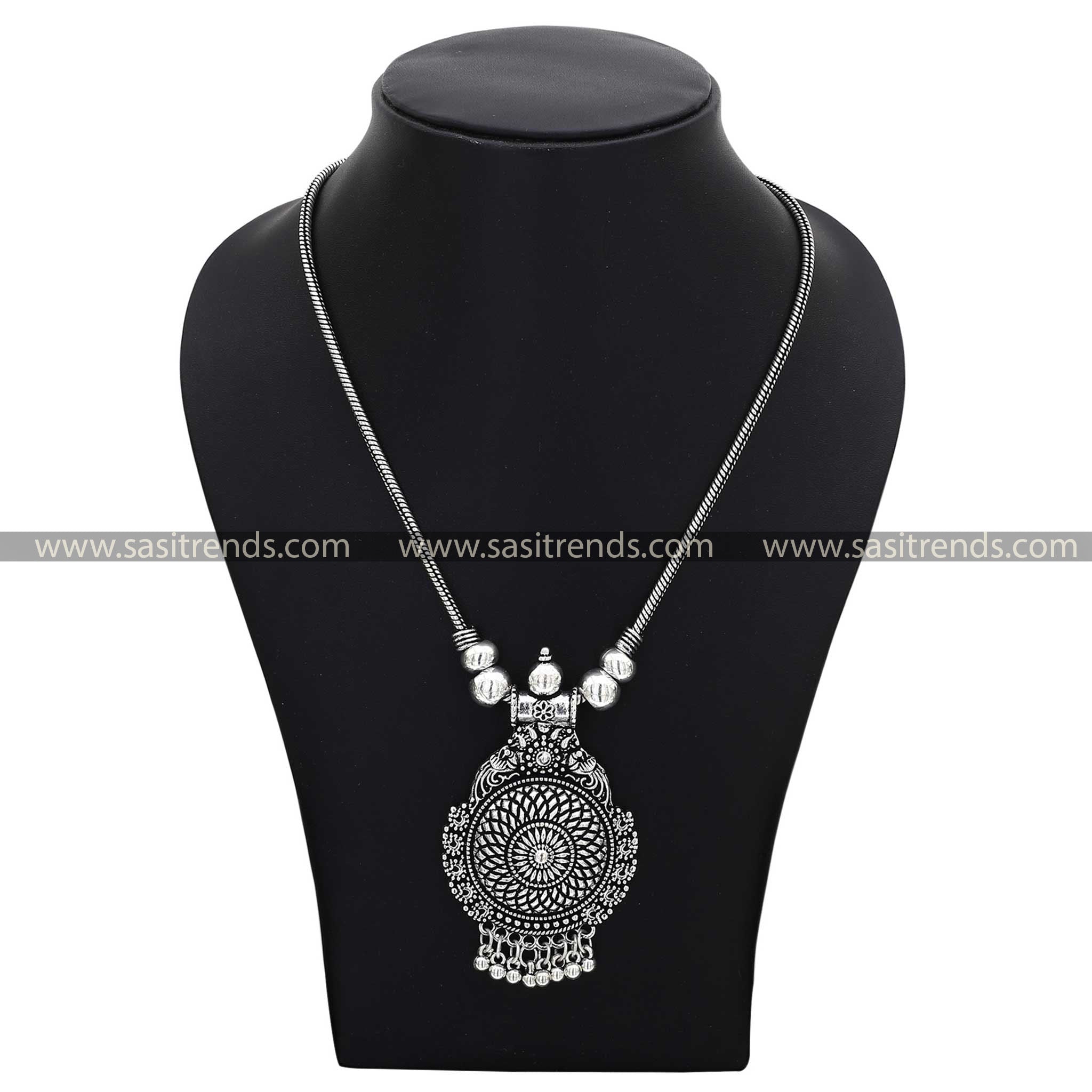 Vintage-style oxidised silver necklace with a detailed pendant showcasing ethnic patterns navarathiri necklace