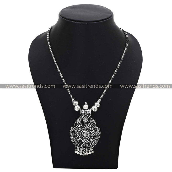 Vintage-style oxidised silver necklace with a detailed pendant showcasing ethnic patterns navarathiri necklace