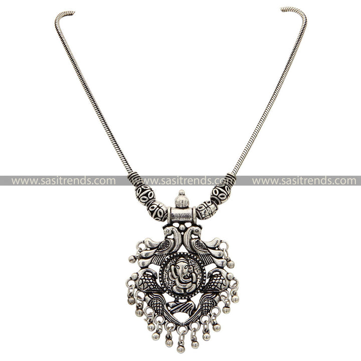 Traditional oxidised silver necklace featuring detailed Ganesha and peacock motifs