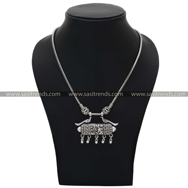 Traditional oxidised silver necklace featuring peacock motifs with tribal-inspired patterns