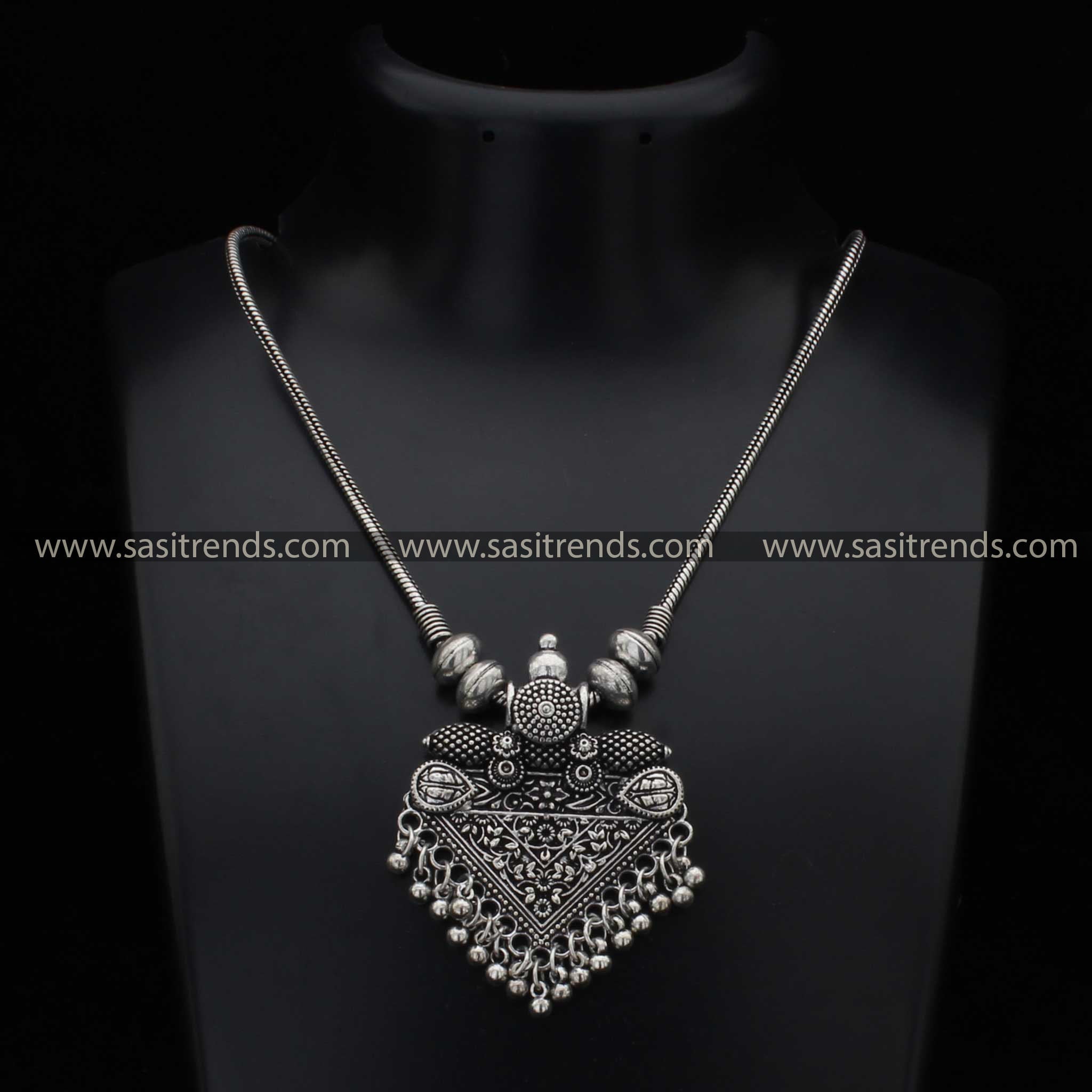 Intricate oxidised necklace with detailed pendant and spherical accents navarathiri elegance sasitrends