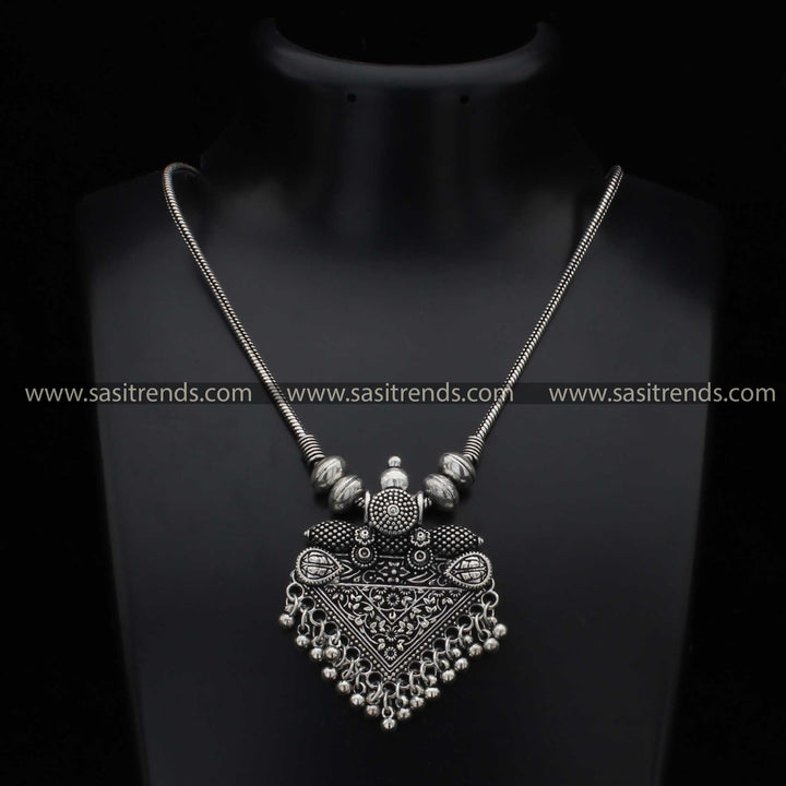 Intricate oxidised necklace with detailed pendant and spherical accents navarathiri elegance sasitrends