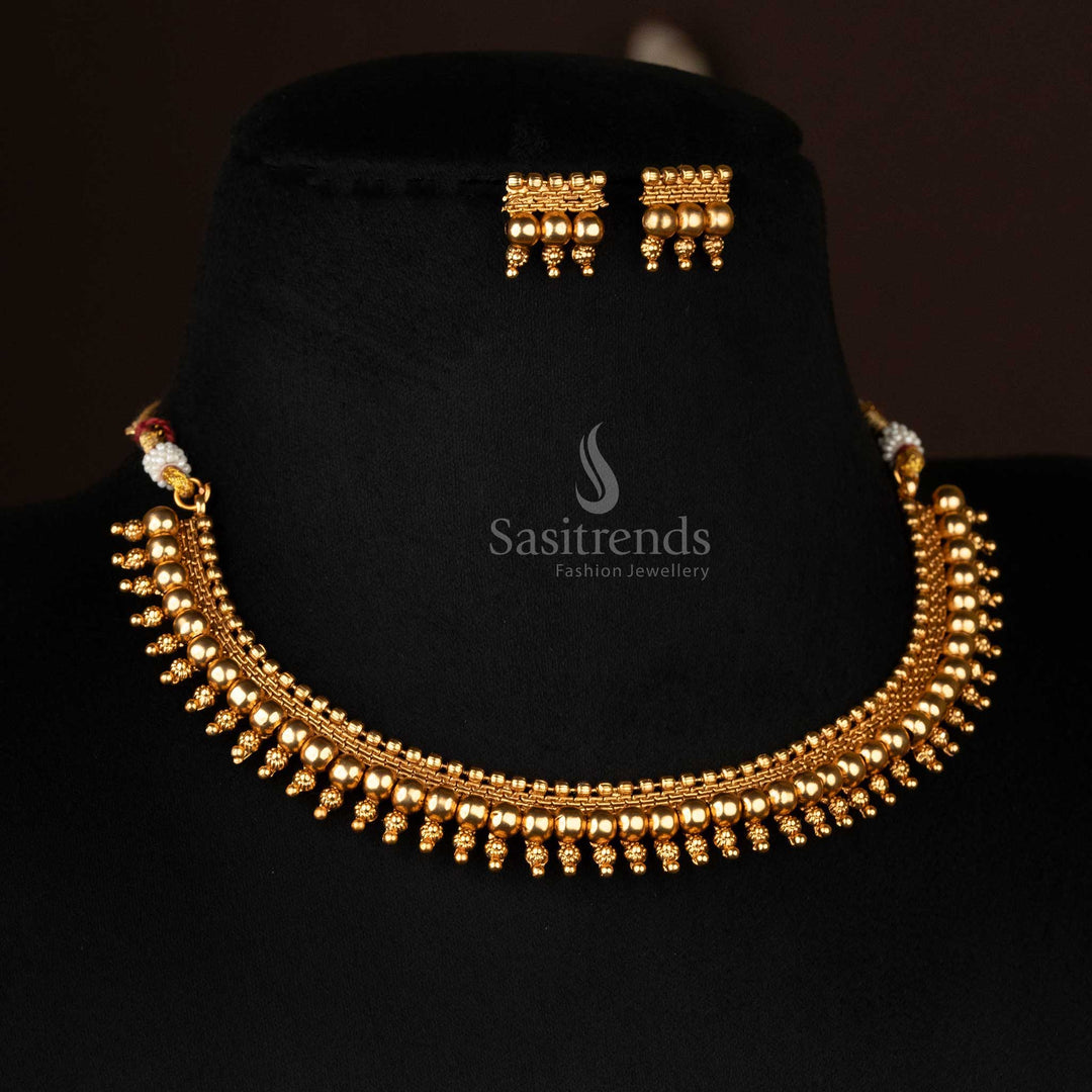 Temple-inspired matte gold-plated ball necklace and earrings displayed beautifully - Sasitrends