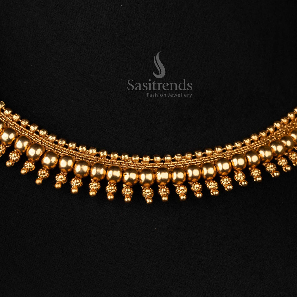 Intricate detailing on matte gold-plated temple necklace ball design - Sasitrends