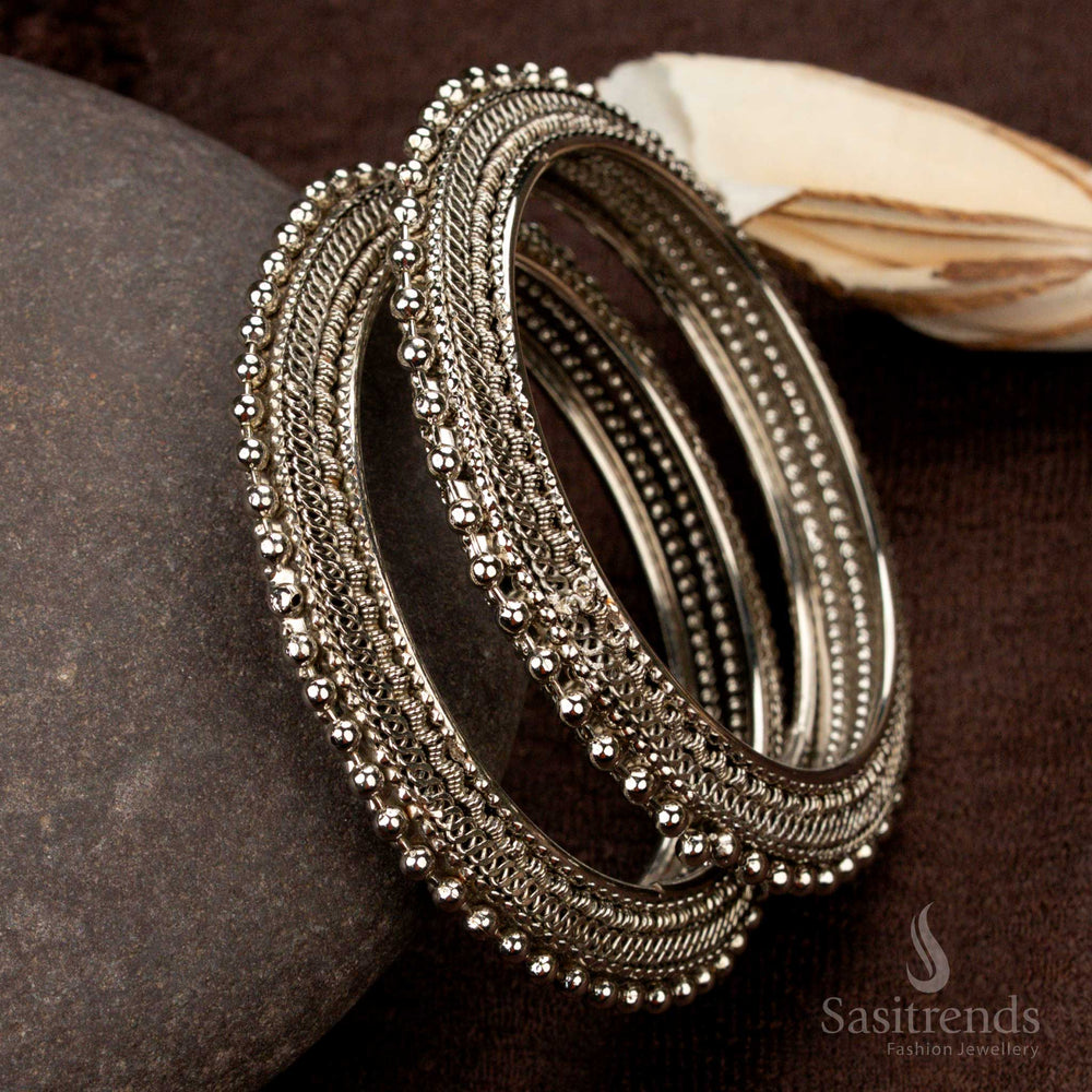 Elegant oxidised silver-plated bangles featuring a classic design with intricate carvings, a handcrafted ethnic jewellery piece perfect for vintage lovers - Sasitrends