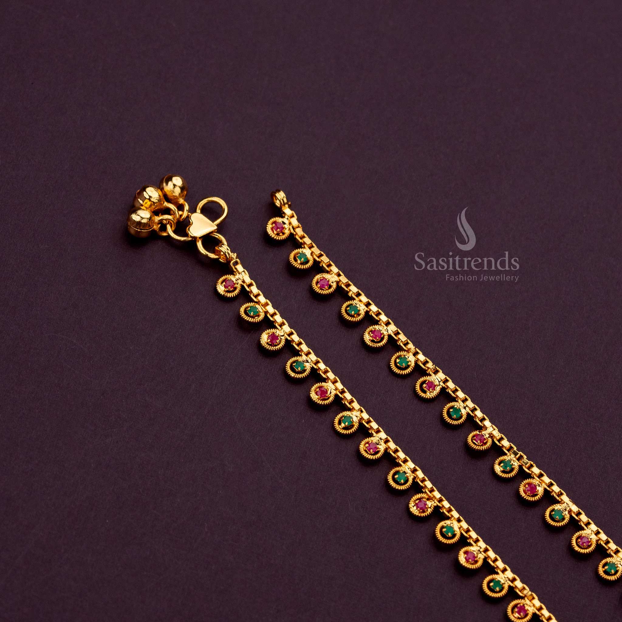 Close-up of luxurious anklets featuring gold loops and accents Ruby Green AD Stones - Sasitrends