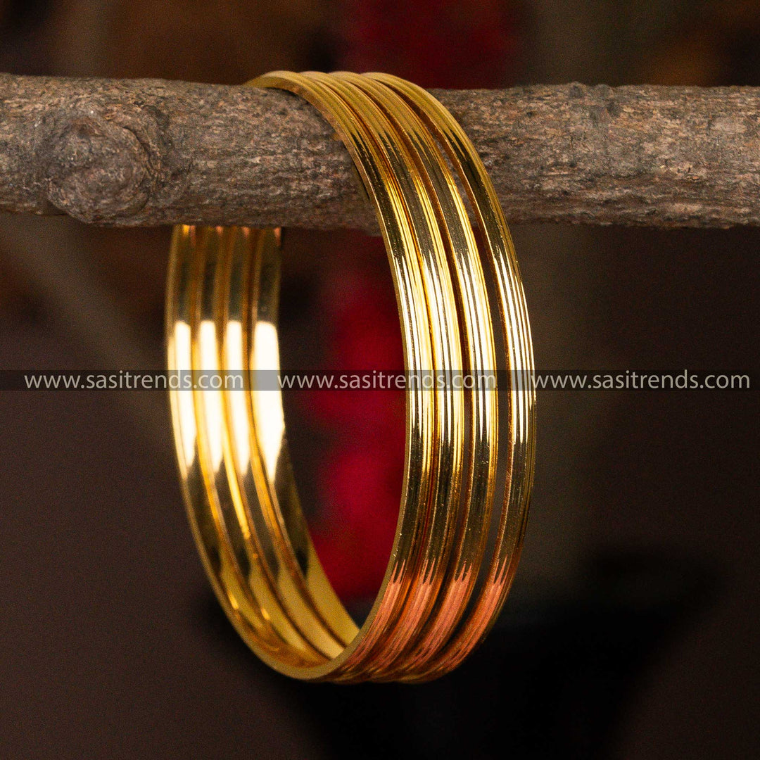 Sleek set of 4 micro gold-plated bangles with a polished, ribbon-like design