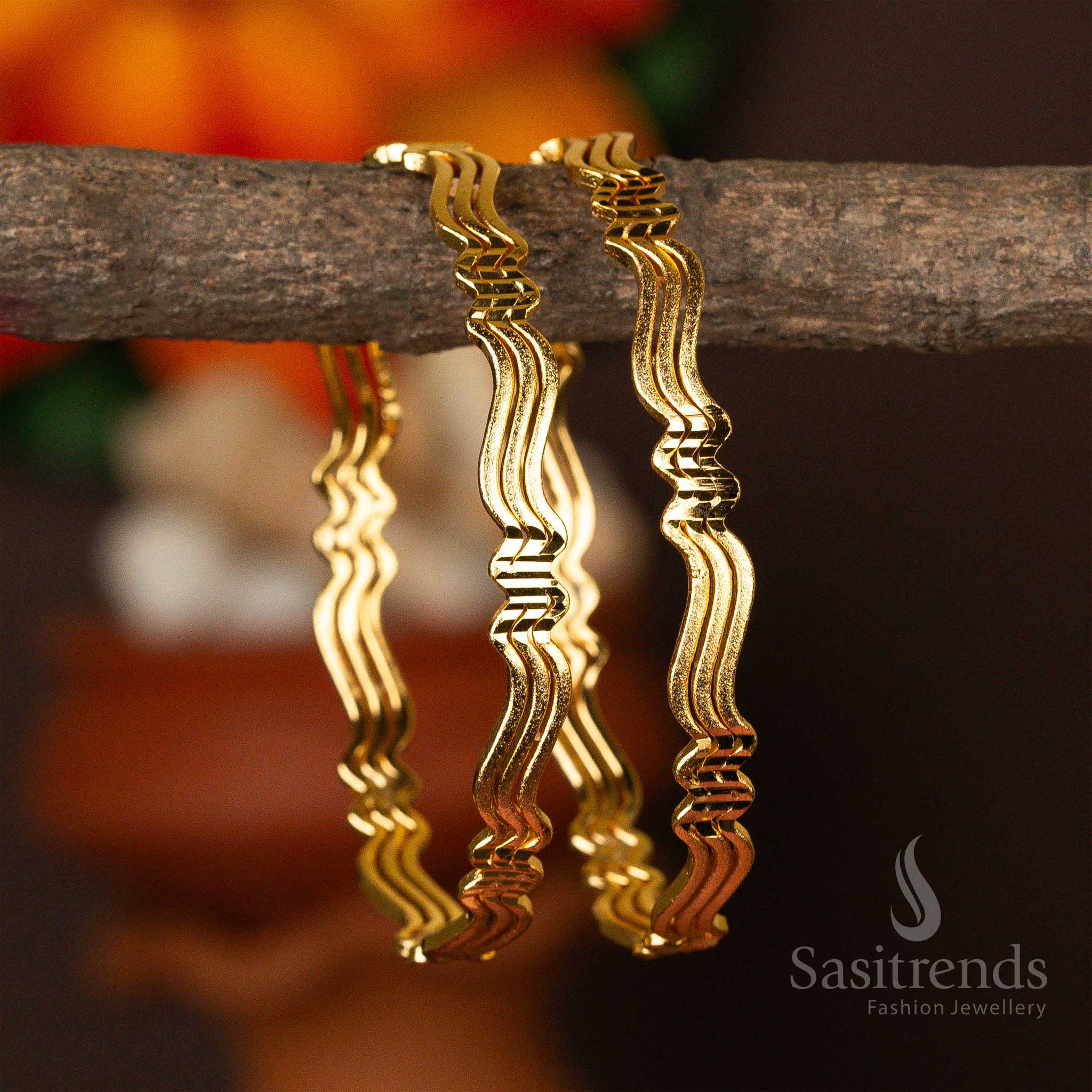 Golden bangles with a serene wave design, plated with micro gold - Sasitrends