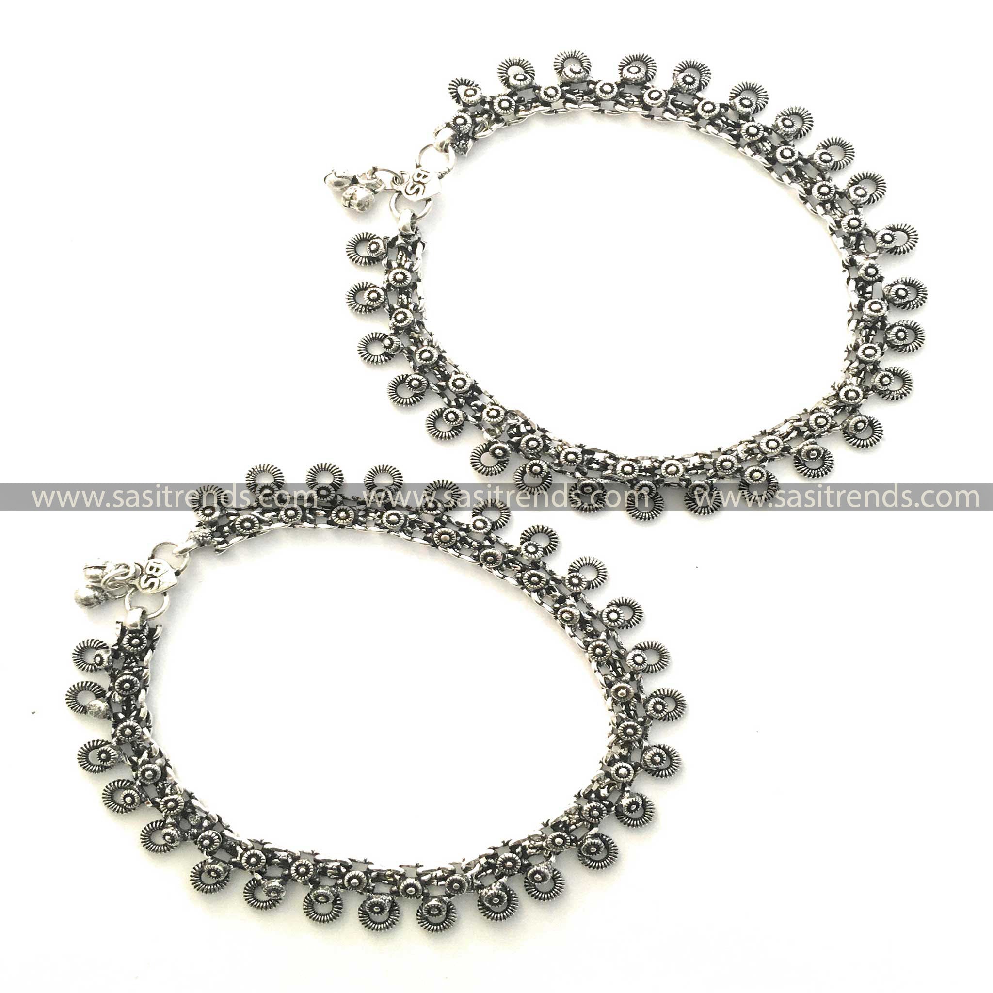 Decorative charm-linked oxidised silver anklets with an embossed clasp 