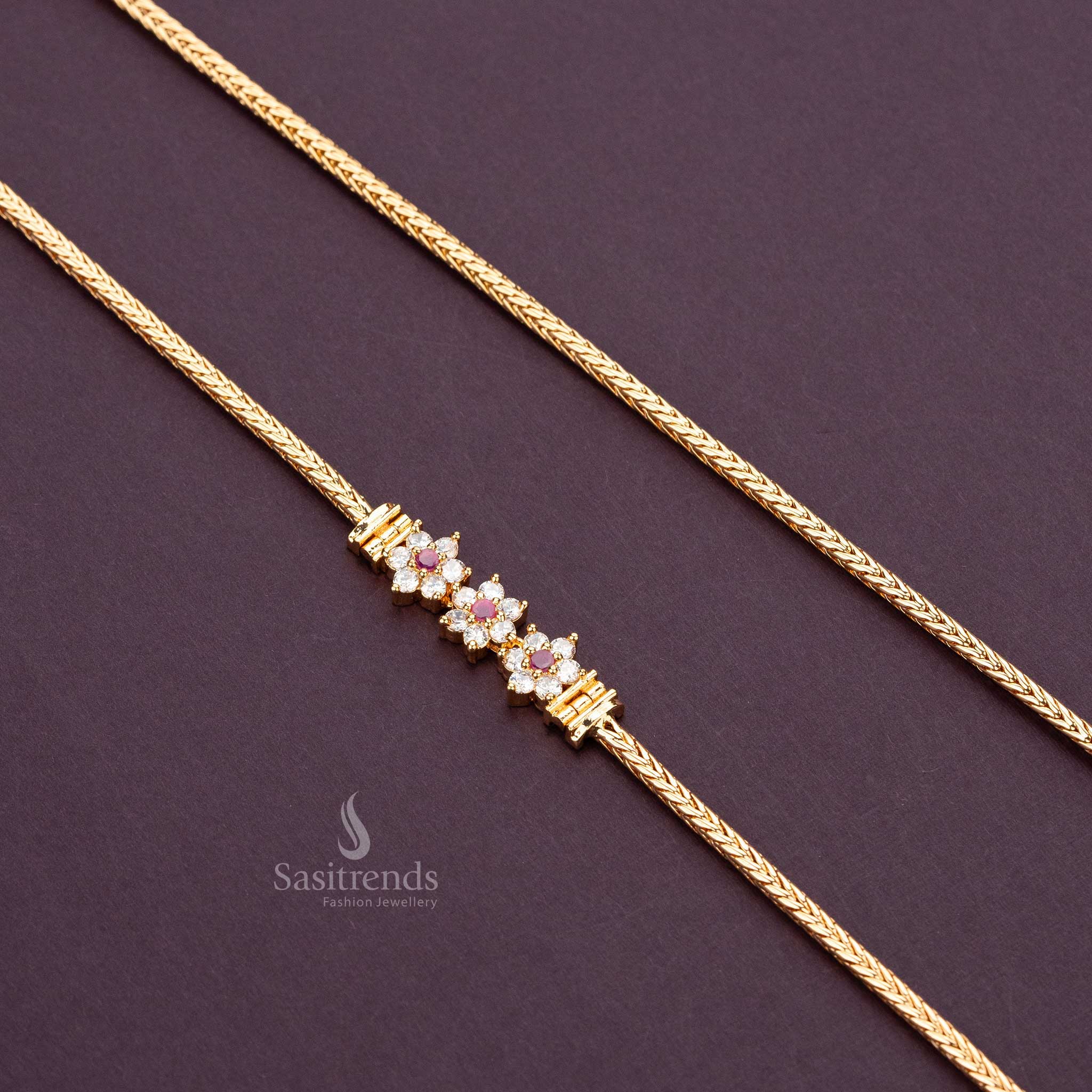 Delicate three-flower design with white and ruby AD stones on a micro gold-plated mugappu chain - Sasitrends