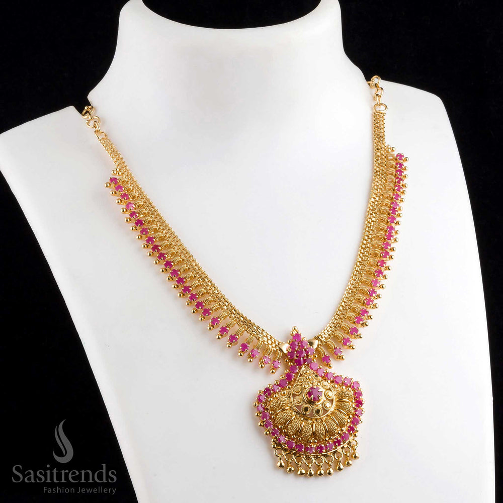 Magnificent grand micro gold plated tilak pendant ruby necklace adorned with golden balls, crafted for an elegant traditional look - Sasitrends