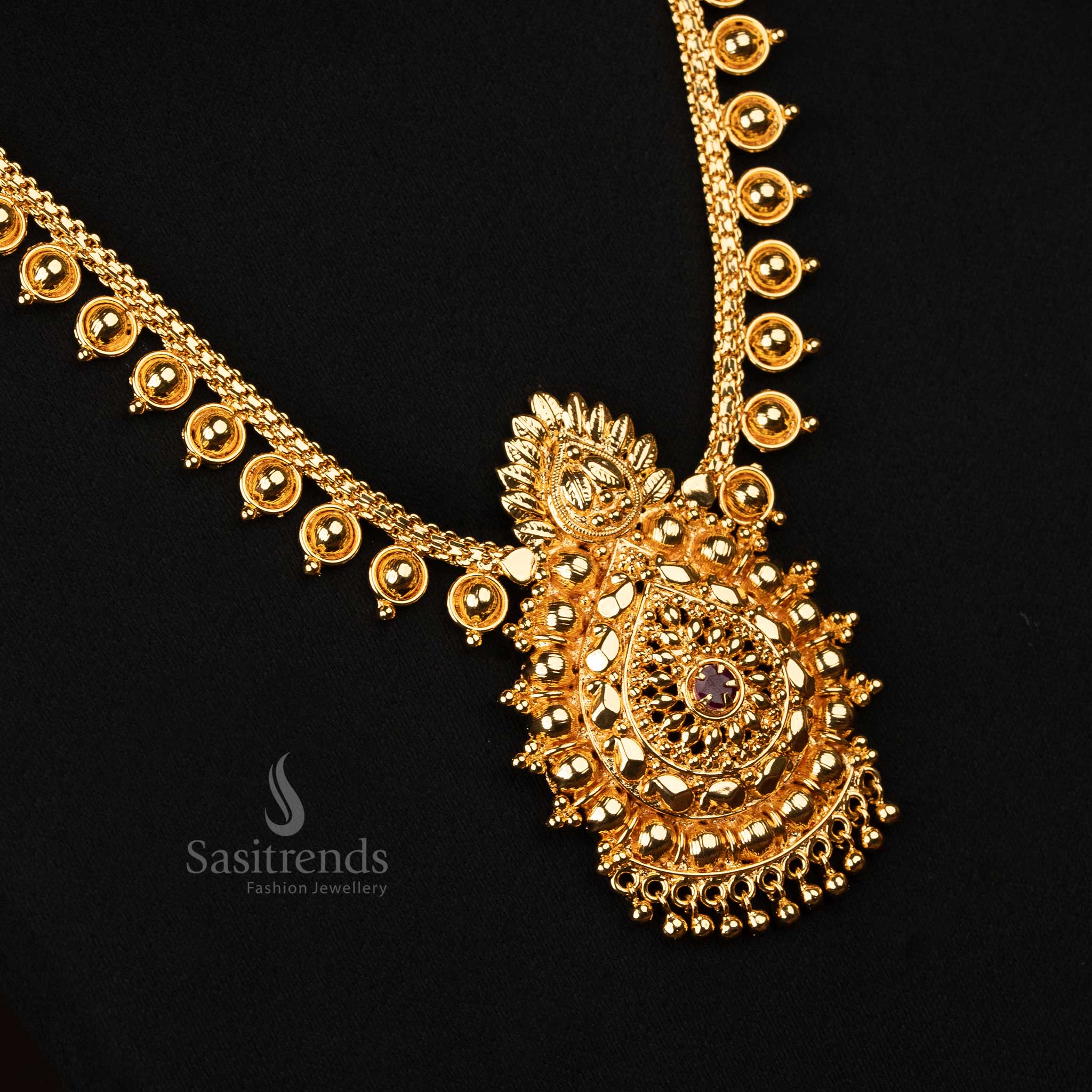 A traditional micro gold-plated long necklace featuring a floral design adorned with ruby AD stones, ideal for weddings and festive occasions - Sasitrends