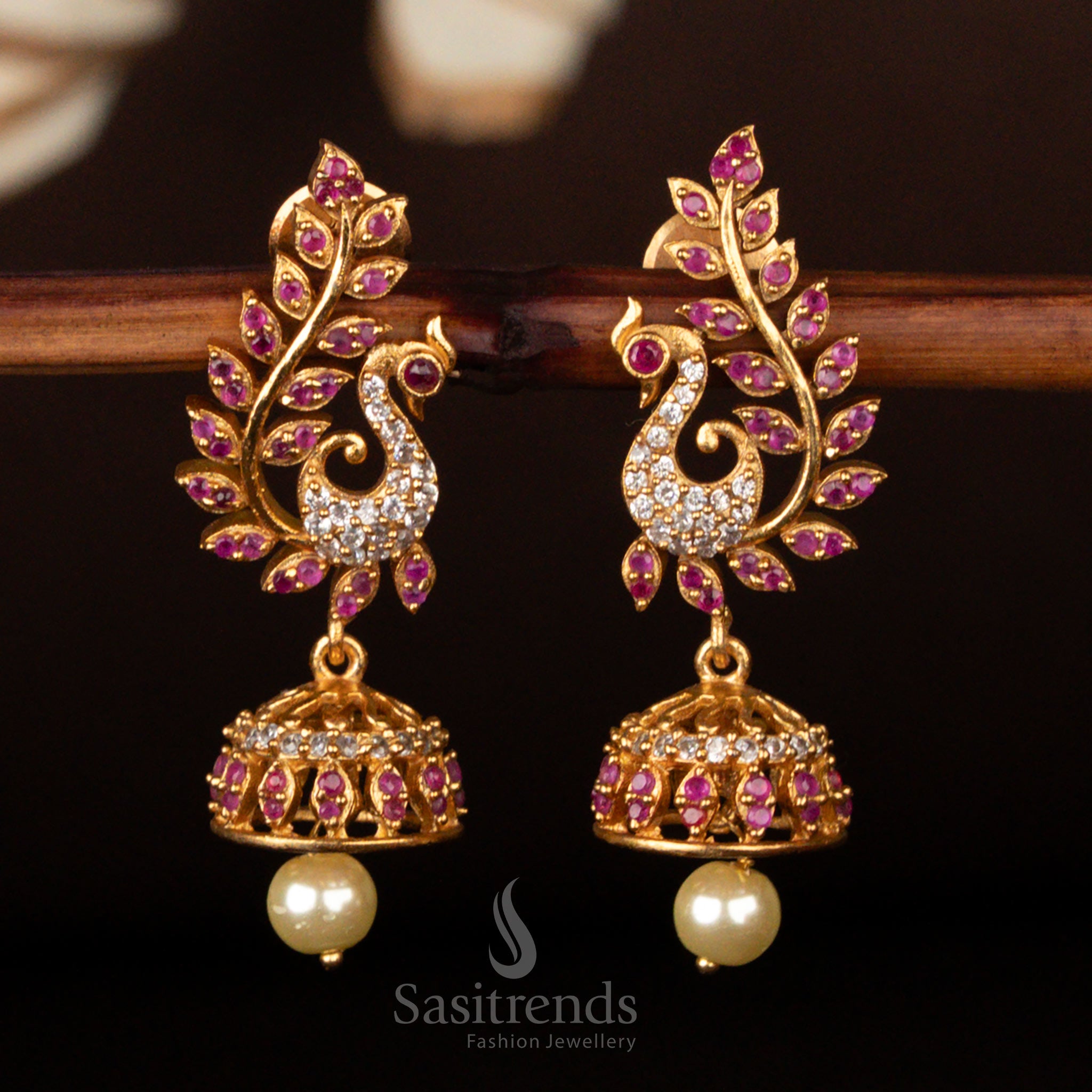 Exquisite ethnic temple design matte gold plated American diamond peacock jhumkas adorned with white and ruby stones, perfect bridal jewellery for traditional occasions - Sasitrends