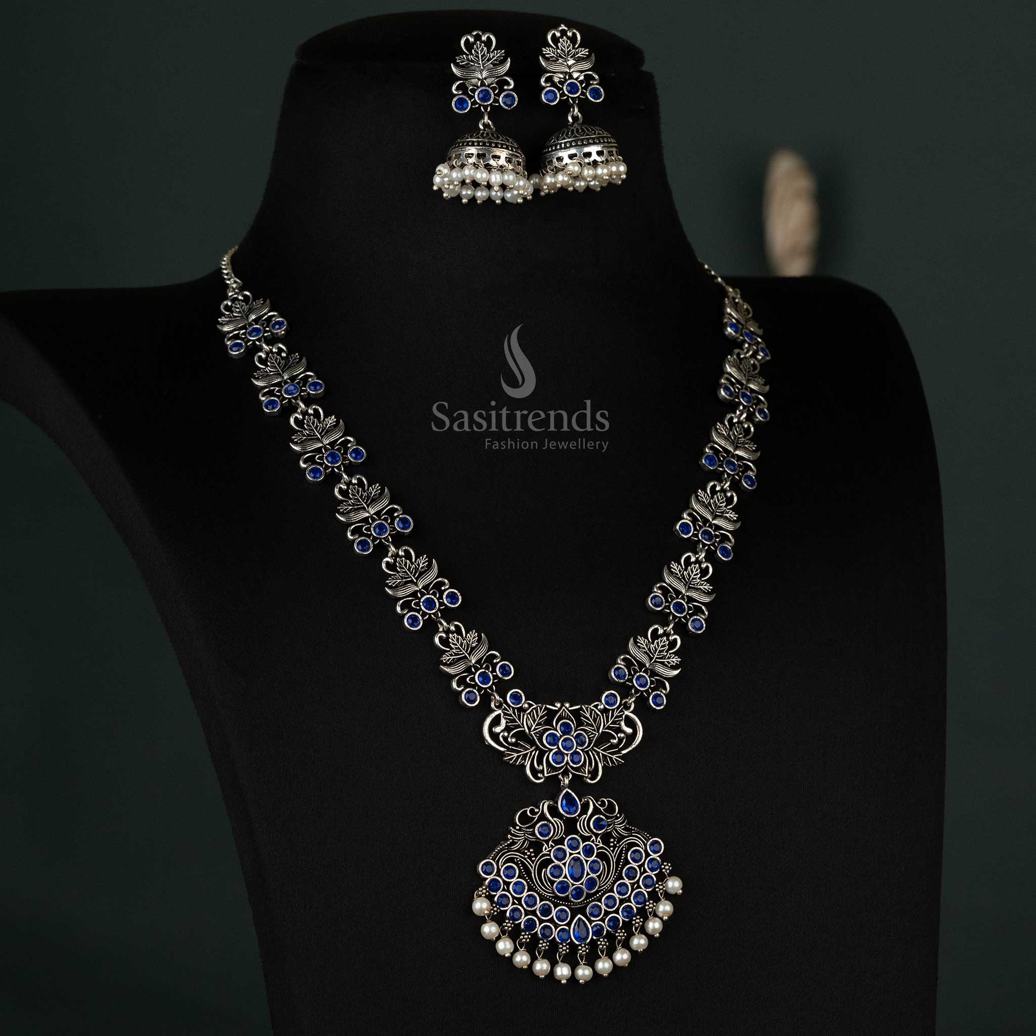 Elegant jewellery set featuring a blue floral pendant with oxidised stones, complemented by delicate pearl jhumkas for party wear - Sasitrends