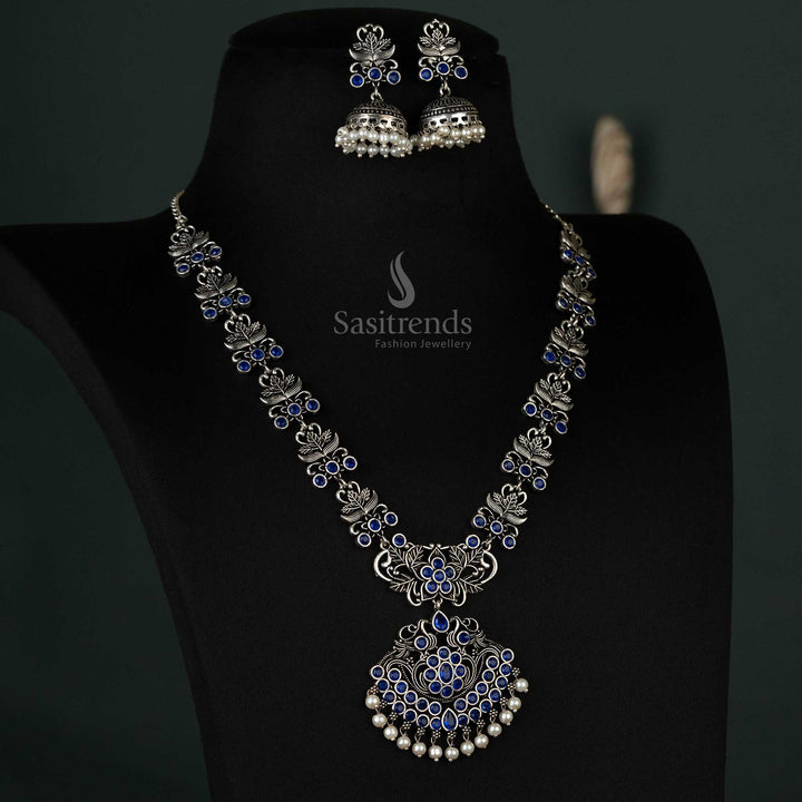 Elegant jewellery set featuring a blue floral pendant with oxidised stones, complemented by delicate pearl jhumkas for party wear - Sasitrends