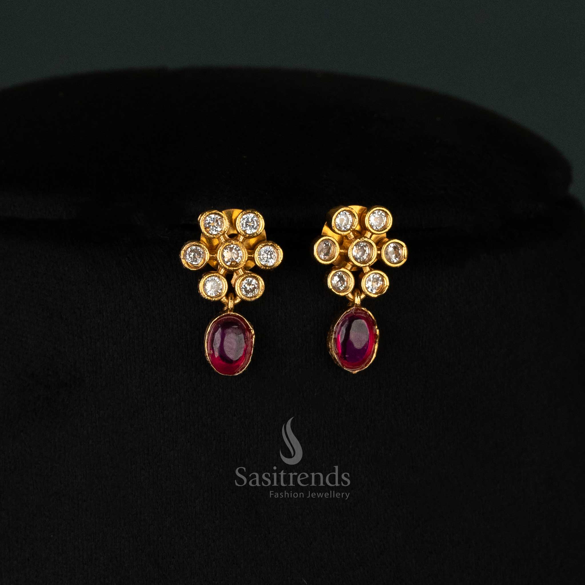 Luxurious ruby earrings set with sparkling American diamonds, floral patterns, and a matte gold finish for a trendy look - Sasitrends