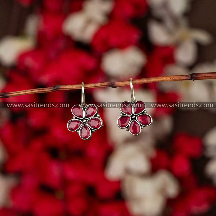 Oxidised petal-shaped earrings with ruby stone accents on fishhook backs navarathiri elegance