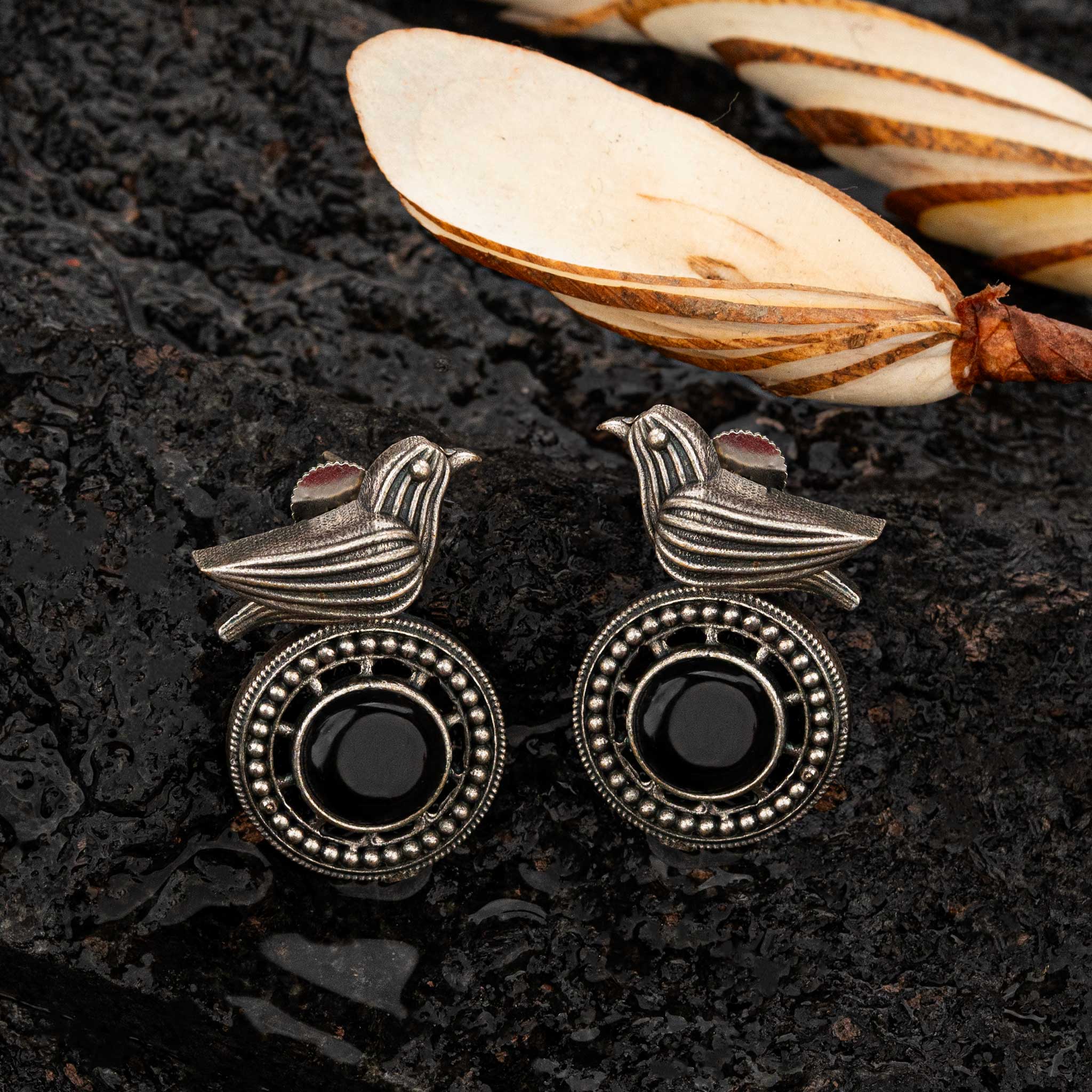 Black oxidised stud earrings with bird motif and circular frame - Sasitrends