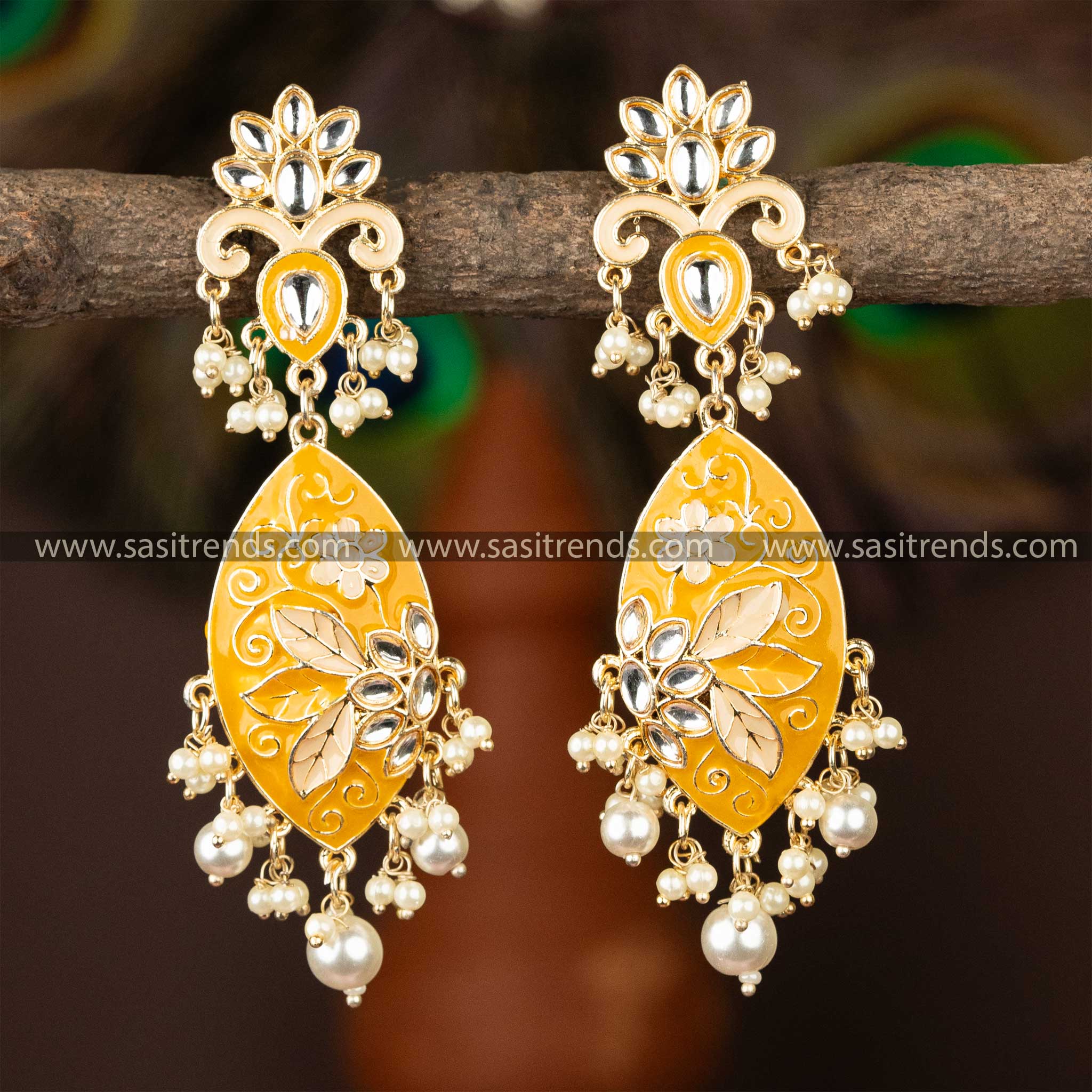 Ornate yellow enamel gold-plated kundan earrings with delicate pearls.