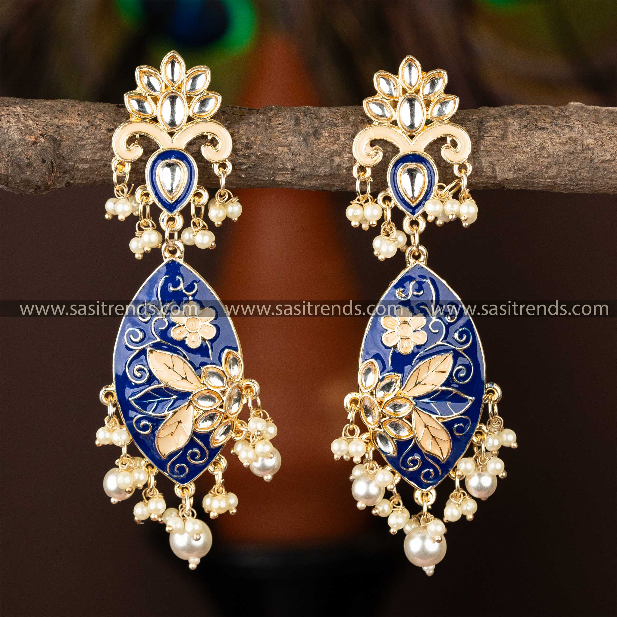 Sophisticated gold-plated kundan earrings with deep blue enamel and pearls.