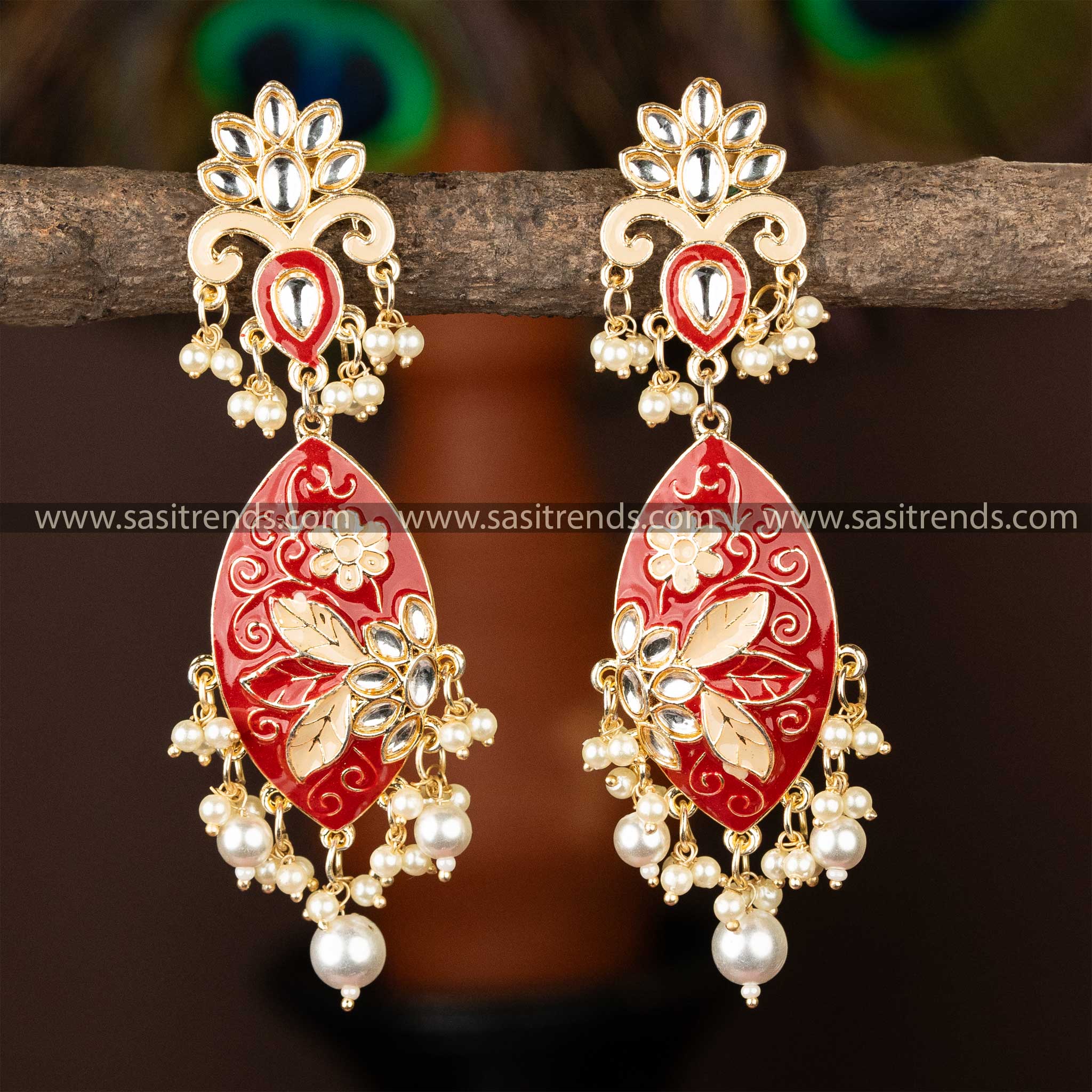 Luxurious red enamel kundan earrings with gold plating and pearl ornamentation.