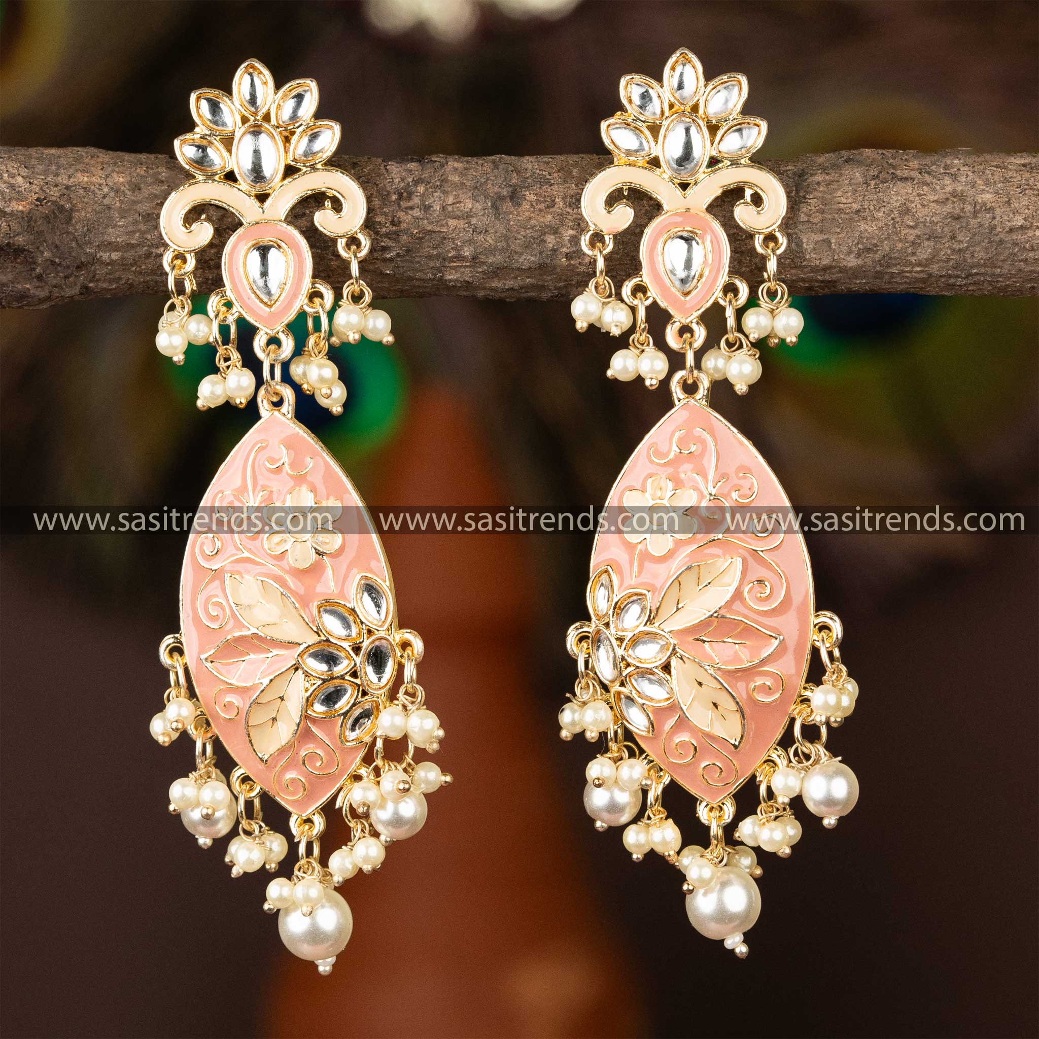 Elegant pink enamel kundan earrings with gold plating and pearl embellishments.