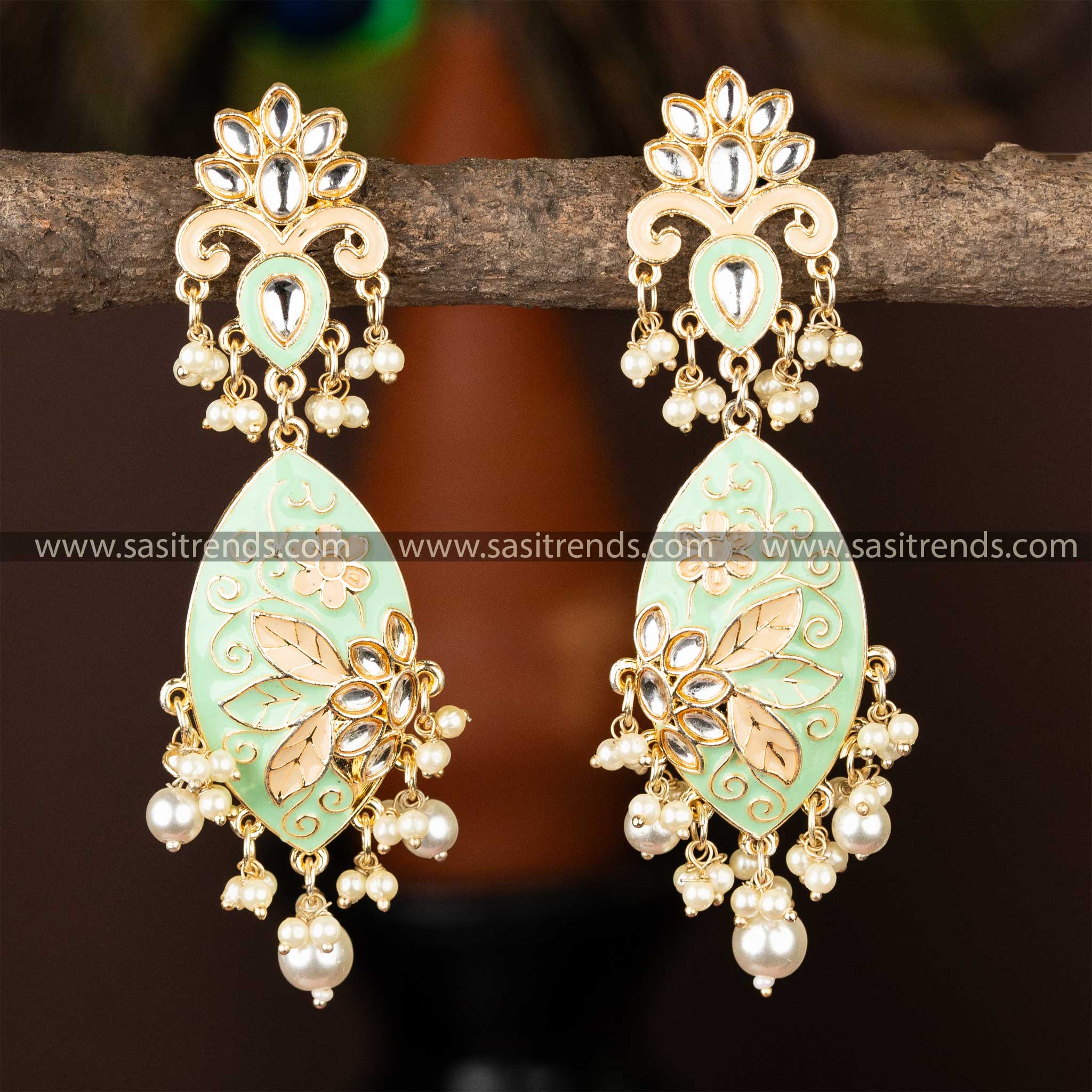 Gold-plated kundan earrings with light green enamel and cascading pearl accents.