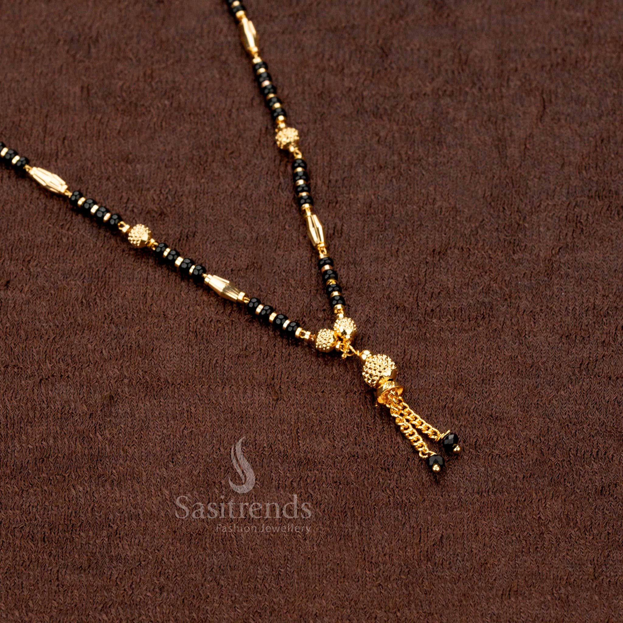 Radiant gold-plated mangalsutra featuring black beads and an aesthetic beaded chain design, enhancing ethnic glamour - Sasitrends