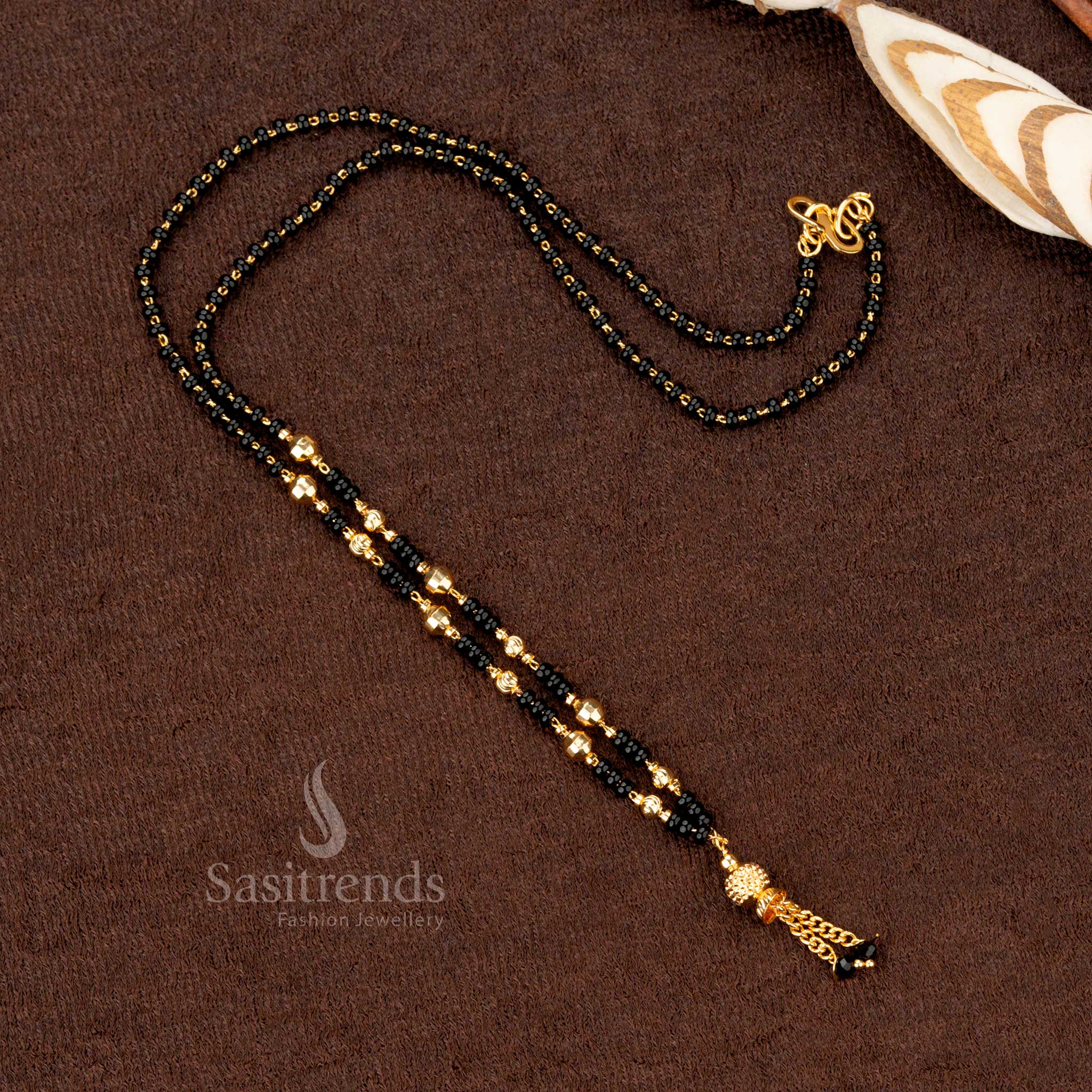 Ornamental gold-plated beaded mangalsutra with black beads, showcasing a royal traditional look for festive and bridal attire - Sasitrends