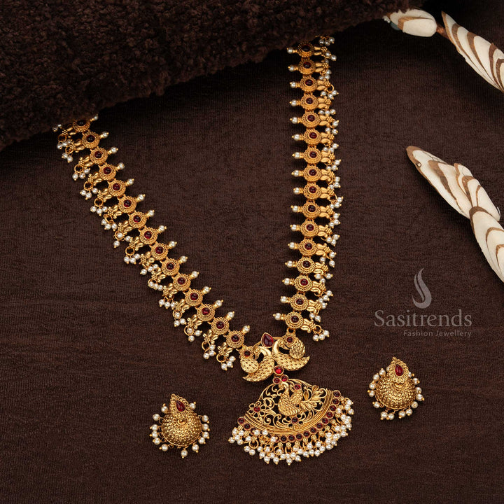 Exquisite ruby stone-embellished matte gold-plated temple peacock long haram necklace, perfect for adding traditional elegance to any outfit - Sasitrends