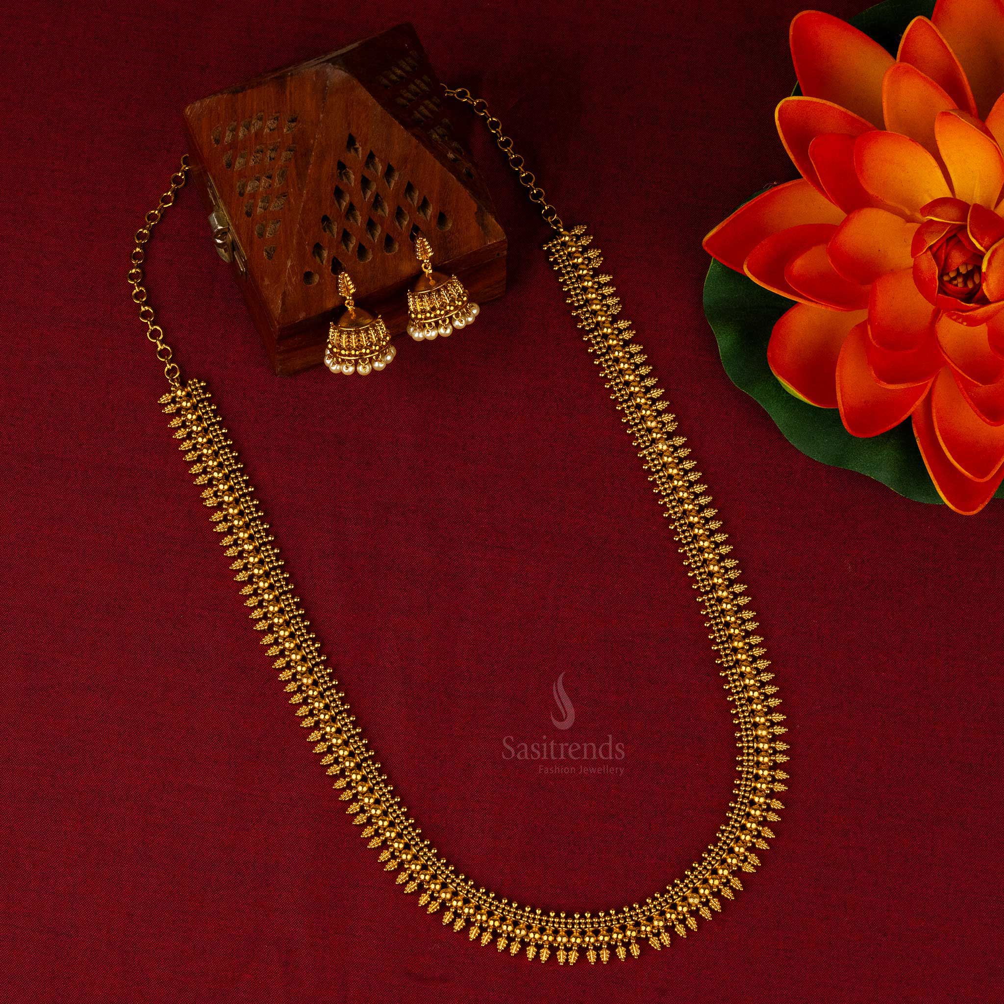 Matte gold plated long temple jewellery set with floral and ball motifs