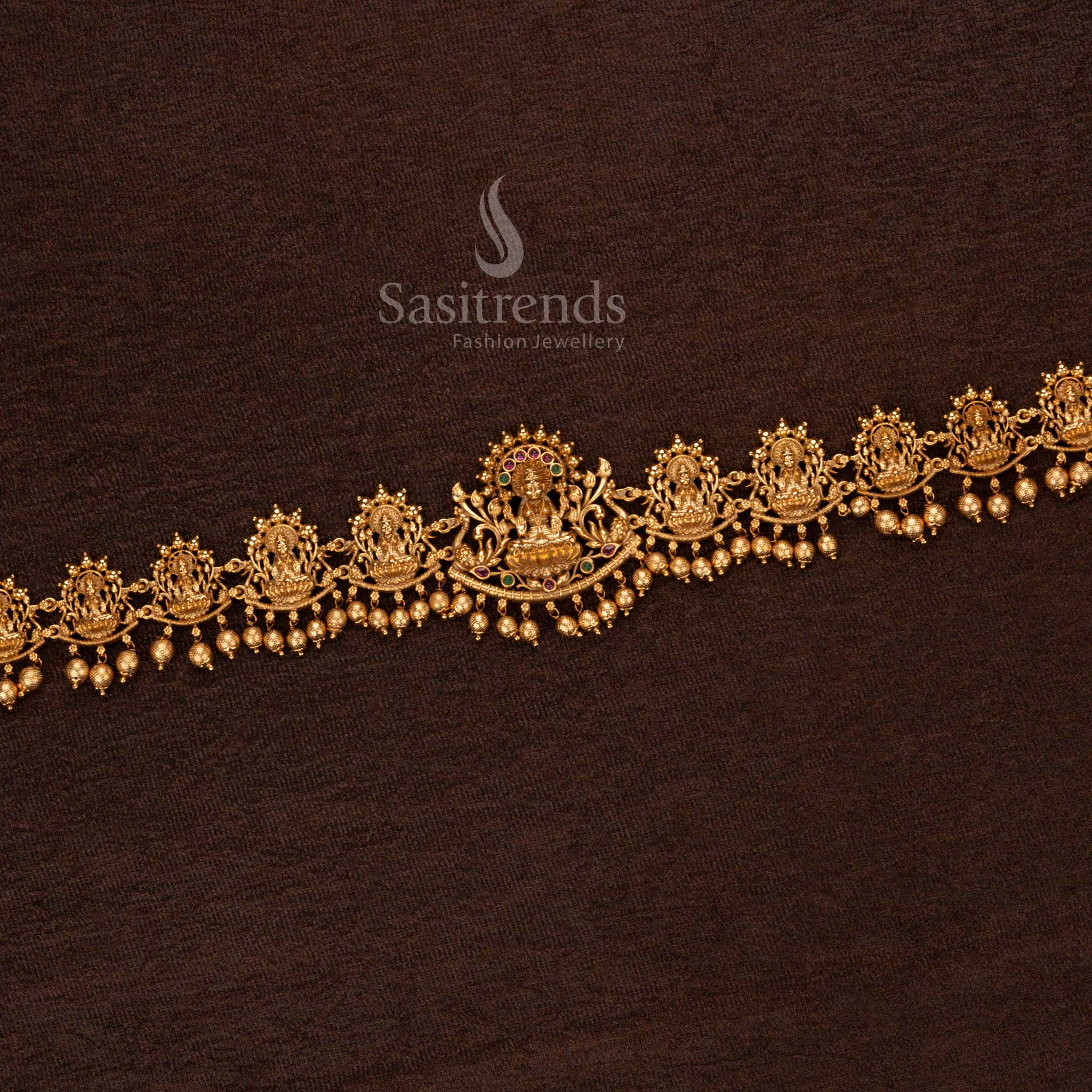 Heritage-inspired matte gold temple vaddanam with Goddess Lakshmi centerpiece, intricate artistry, and delicate beads – Sasitrends