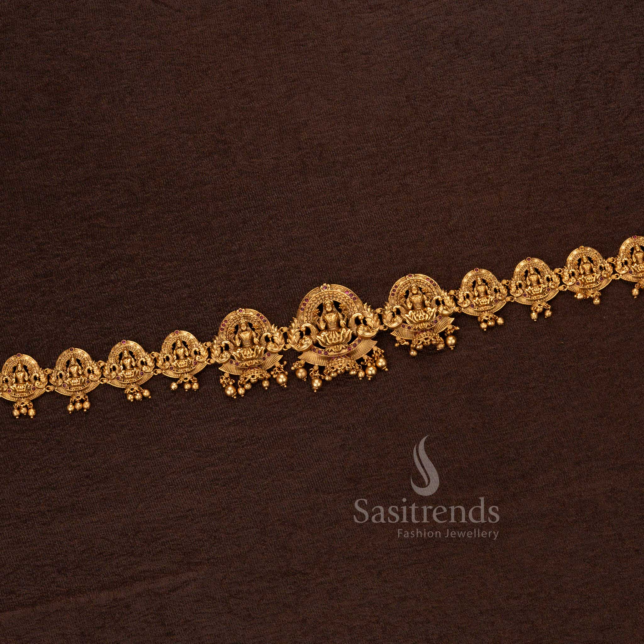 Intricately crafted matte gold traditional temple waist chain with precious blood-red ruby stones and divine Lakshmi idols - Sasitrends