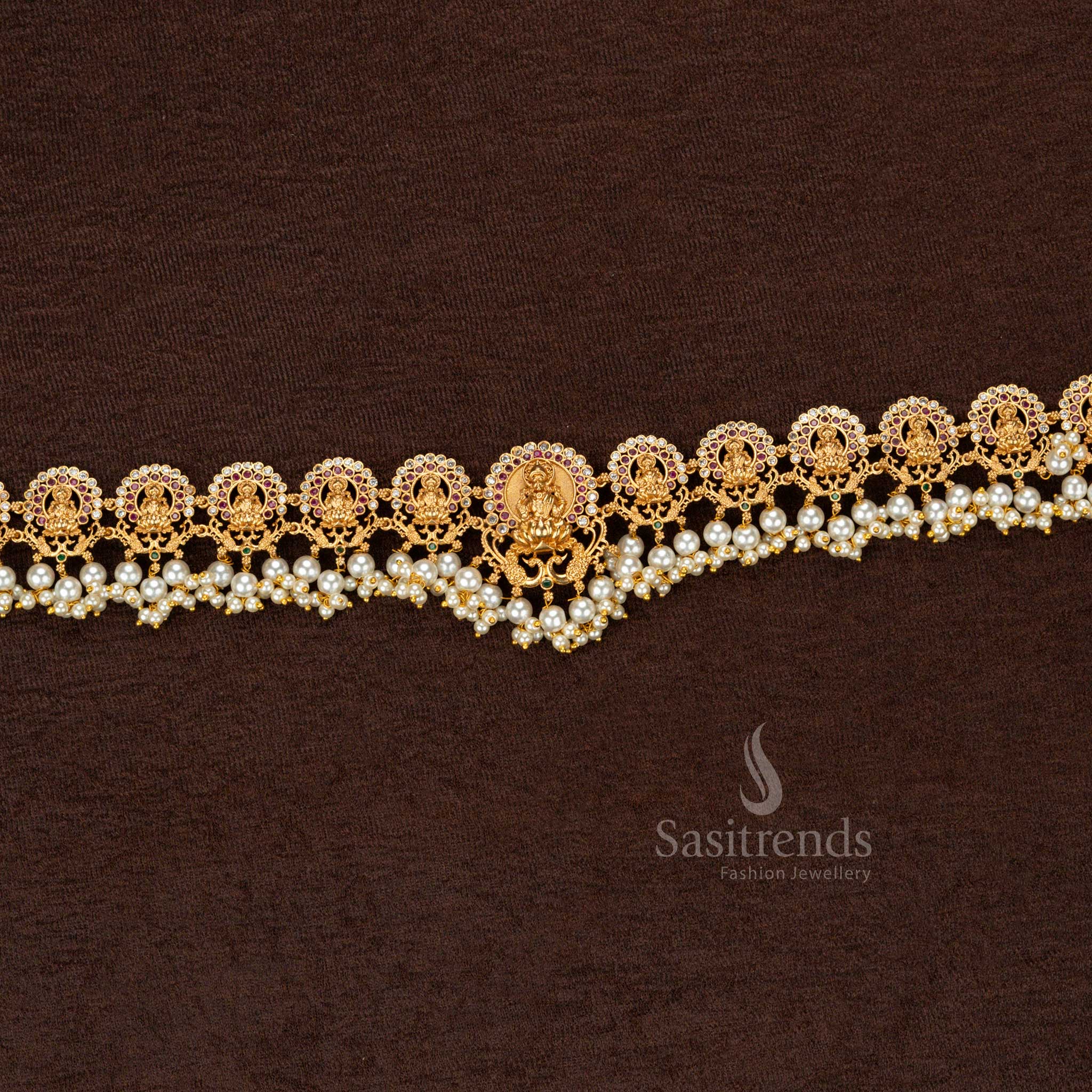 Antique-finish matte gold temple hip belt showcasing a divine Lakshmi motif with exquisite full pearl embellishment, a masterpiece in handcrafted heritage jewellery - Sasitrends