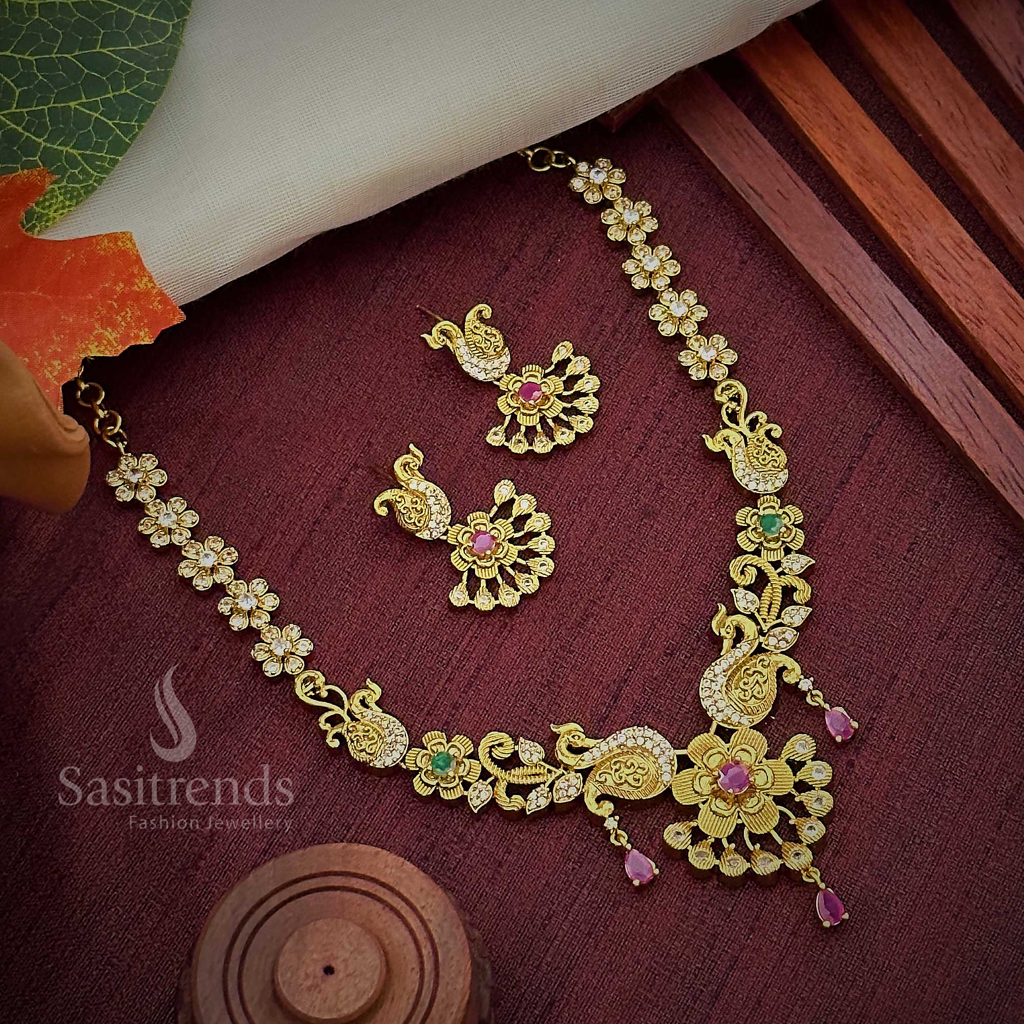 Gorgeous Peacock and Flower Necklace Set: Ruby Hangings, American Diamond Stones, Brass Material, Matte Gold Finish - Sasitrends