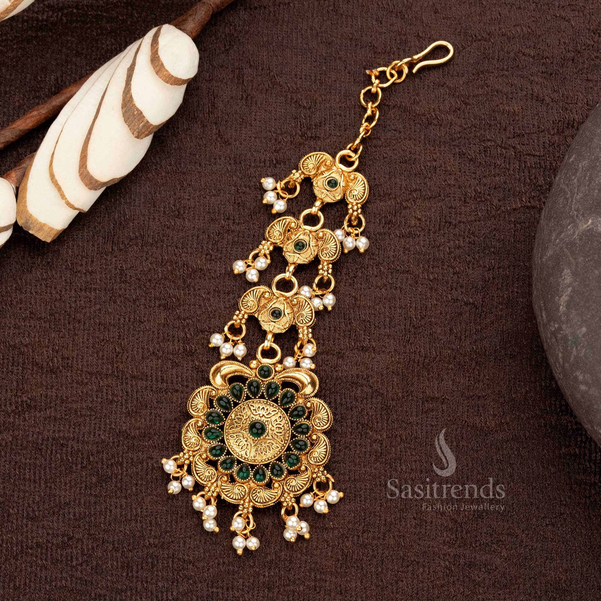 Classic matte gold maang tikka with green stones and pearl embellishments - Sasitrends