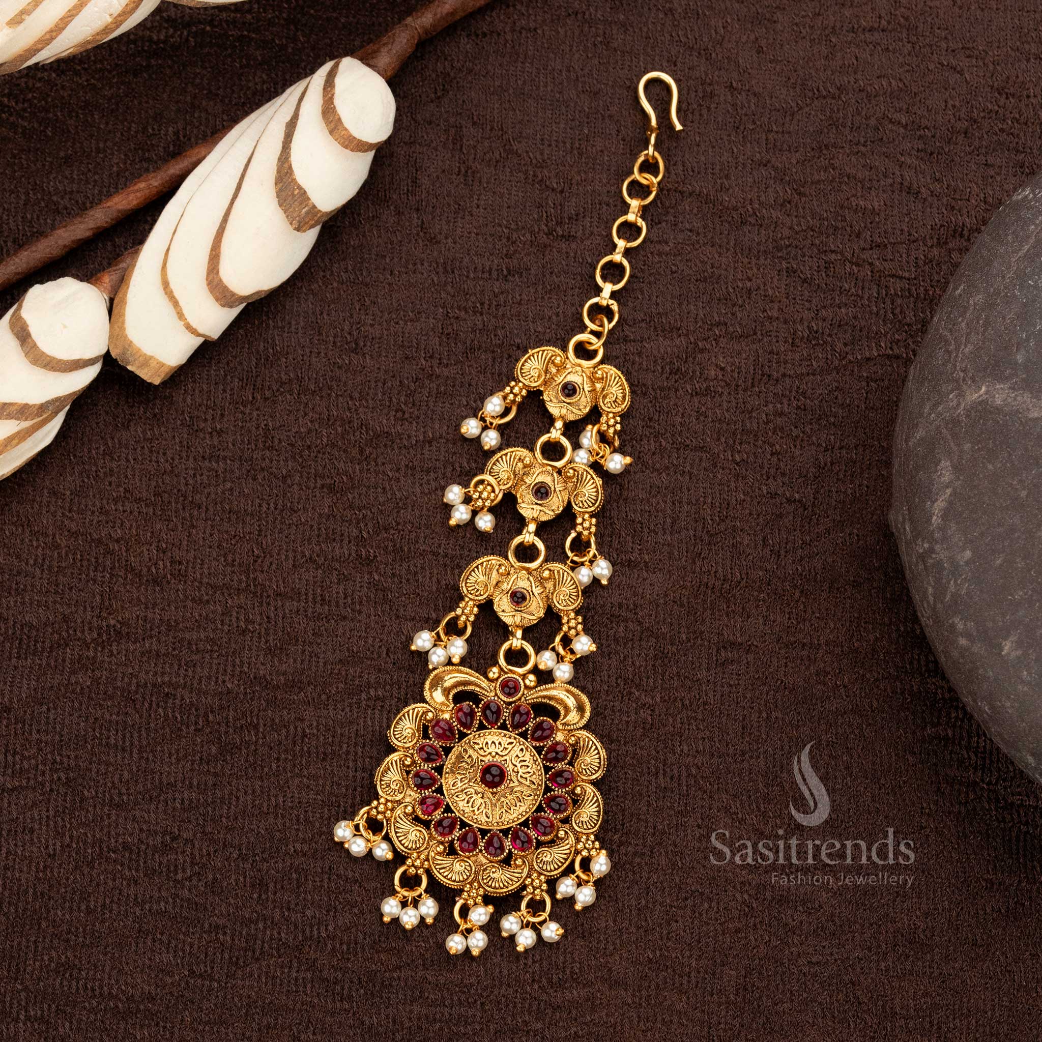 Matte gold floral maang tikka with ruby synthetic stones and pearl hangings - Sasitrends