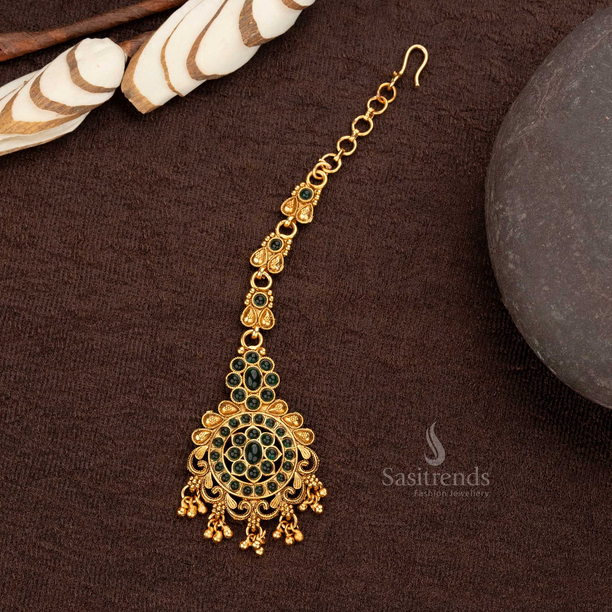 Elegant Temple Maang Tikka with green stones, floral pendant, and ball hangings - Sasitrends