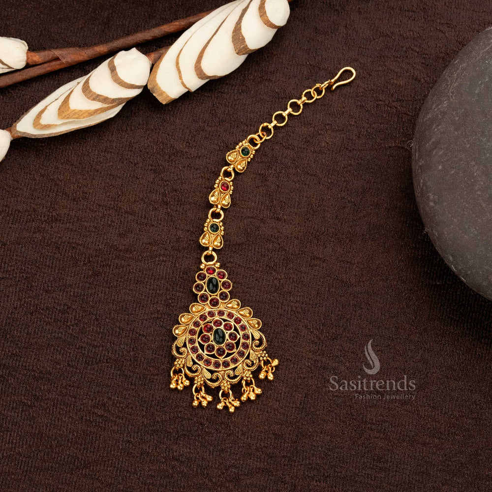 Ruby-green Temple Maang Tikka with intricate engravings and golden balls - Sasitrends