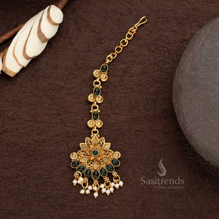 Temple maang tikka with green floral motif and matte gold finish for weddings - Sasitrends