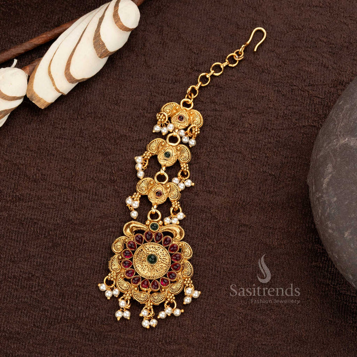 Floral pendant maang tikka with ruby-green stones in matte gold finish - Sasitrends