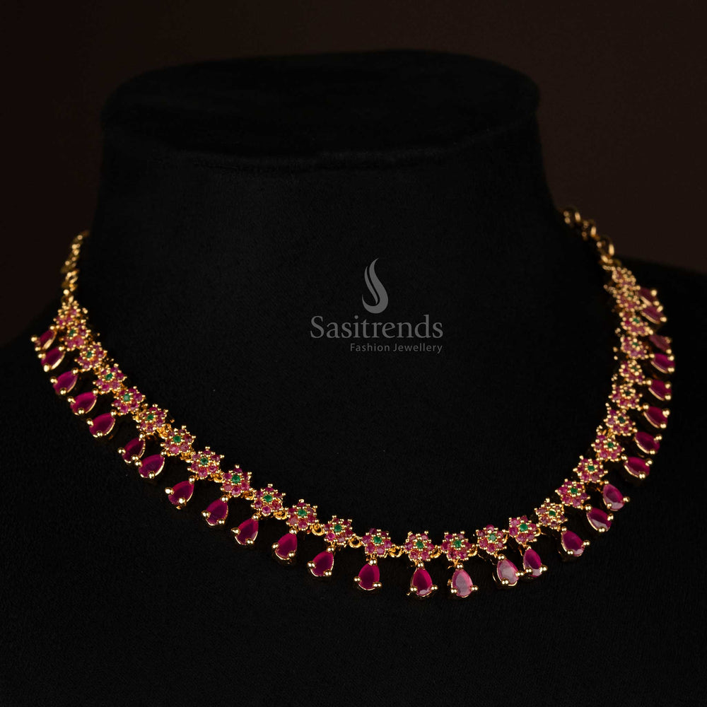 Elegant one gram gold-plated necklace with floral motif and ruby accents, adorned with sparkling AD stones - Sasitrends