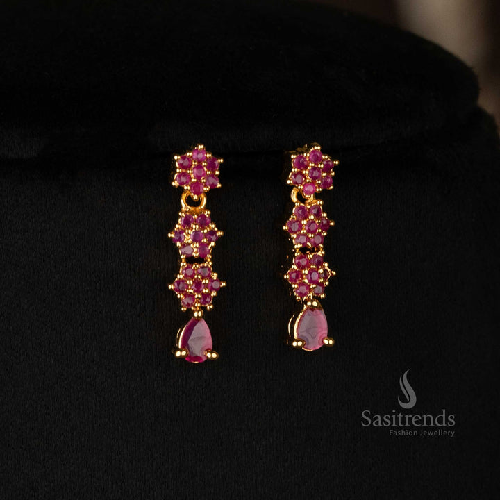 Gold-plated floral Earrings set with ruby detailing and shimmering American diamond stones - Sasitrends