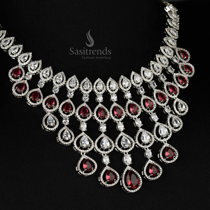 Luxurious red bridal jewellery ensemble in rhodium plating, embellished with dazzling American diamonds for grand bridal occasions - Sasitrends